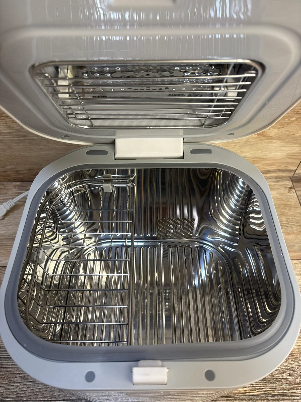 Open stainless steel sterilizer or bottle sanitizer with removable wire racks