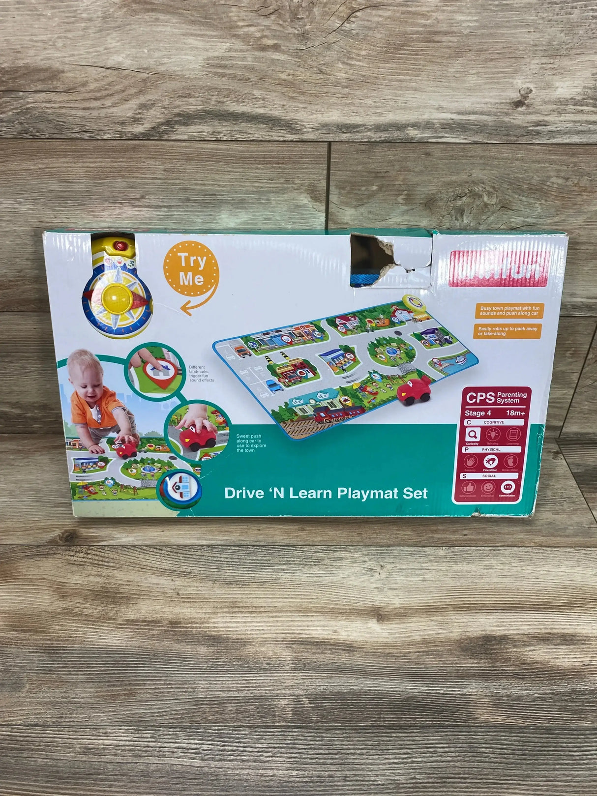 Front view of Winfun Drive N Learn Playmat Set showing playmat artwork, red push car, Try Me button on wood floor background