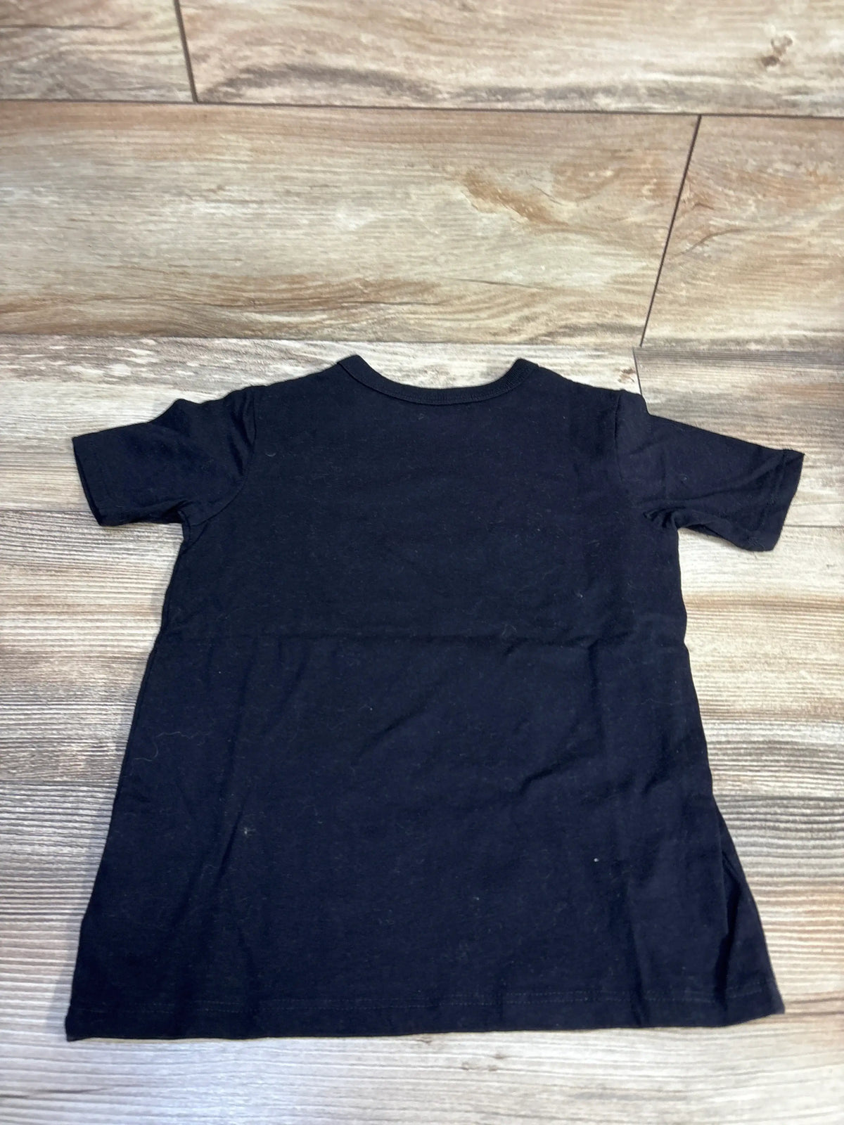 Flat lay of Children’s Place black Halloween construction vehicle shirt, size 5T, with short sleeves and crew neck