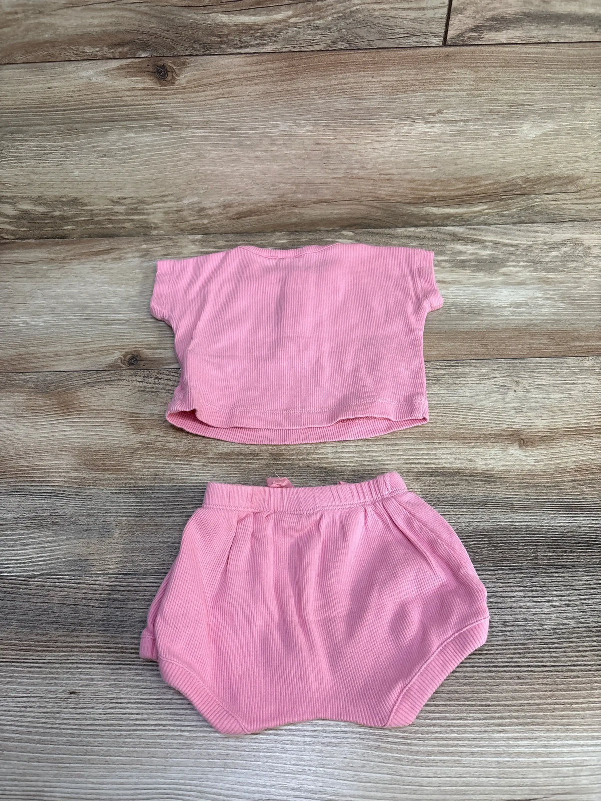 Front view of Baby Gap pink ribbed Henley top and bloomer shorts showcasing short sleeves and drawstring detailing