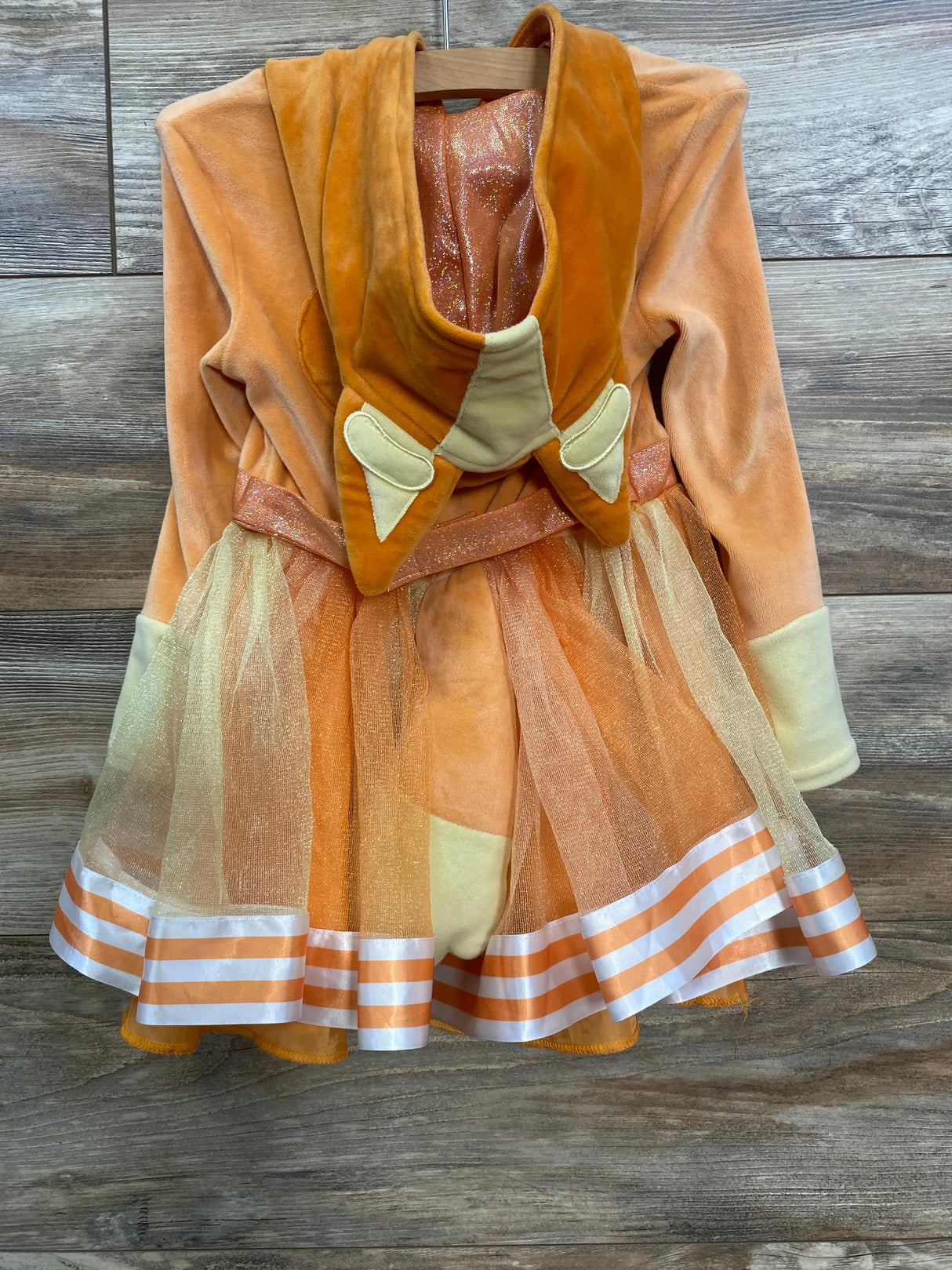 Orange velvet kids costume dress with tulle skirt and striped hem, perfect for play or dress-up.