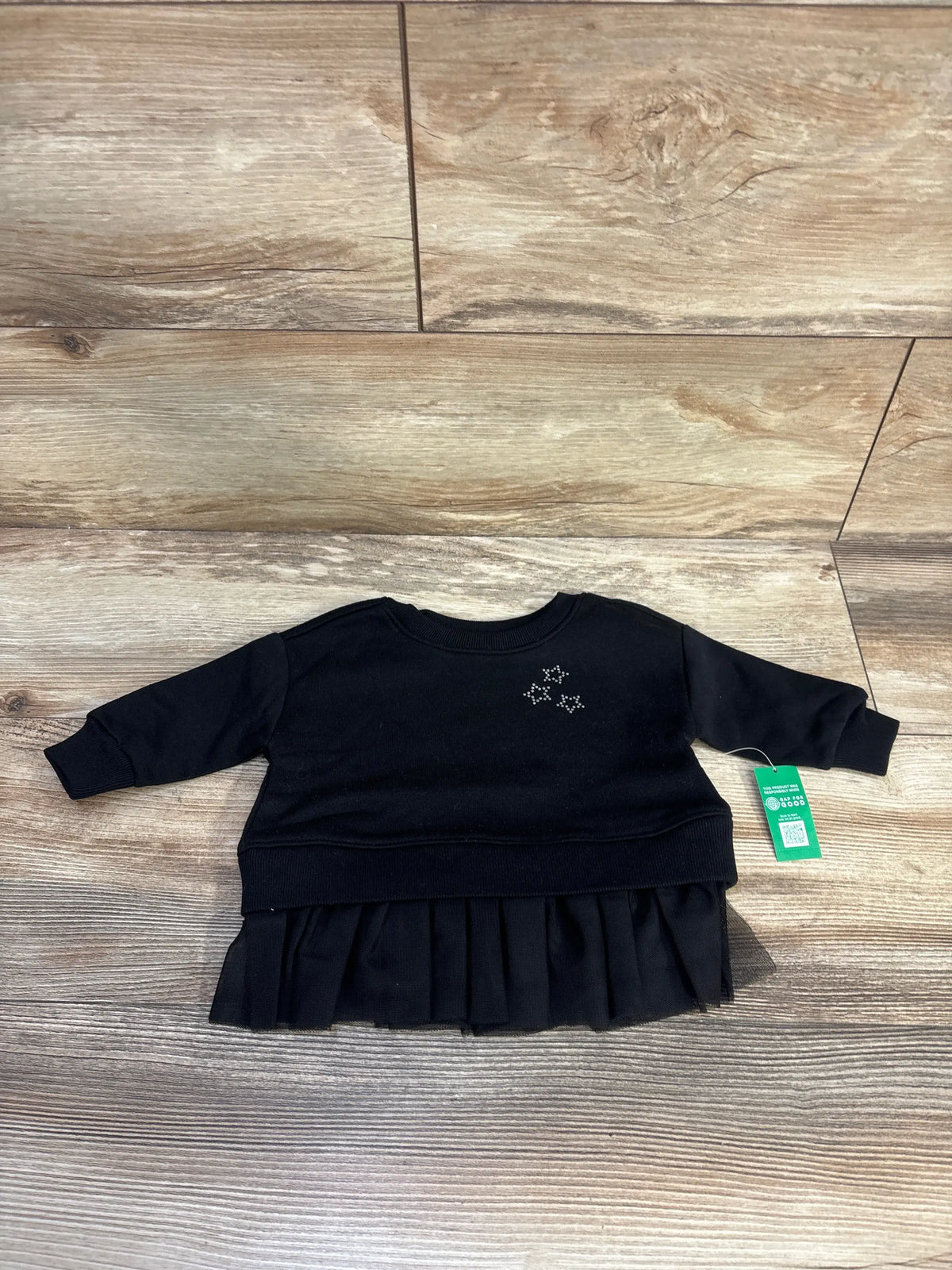 Front view of black Baby Gap VintageSoft tulle sweatshirt showcasing long sleeves and pleated tulle hem on wood-look floor