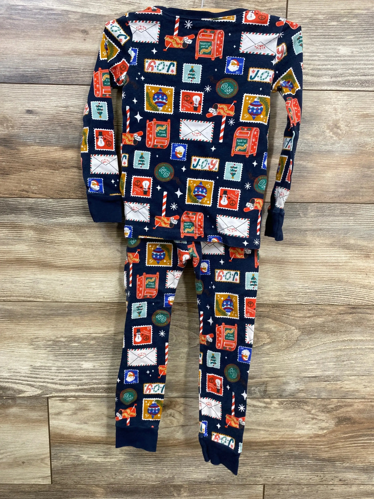 Festive holiday pajama set with Christmas stamp print, perfect for kids' winter nights.