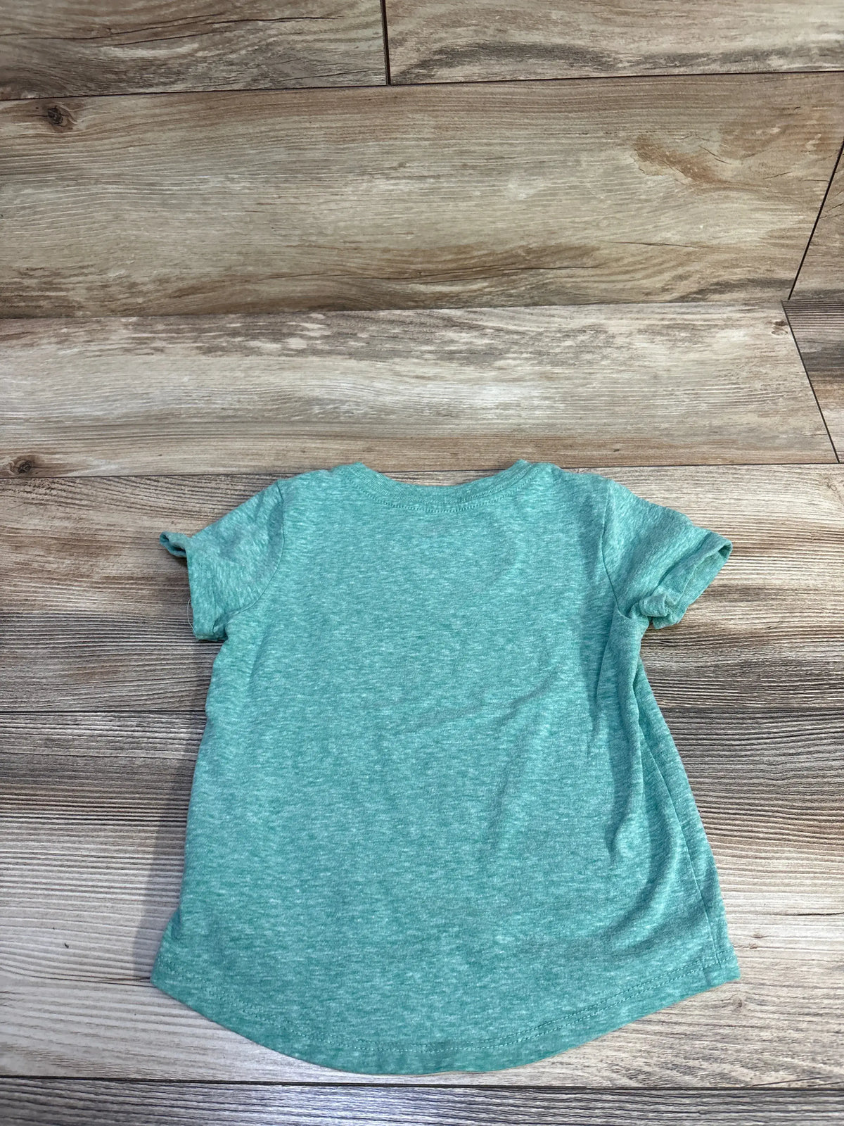 Back view of Cat & Jack short-sleeve green heather toddler t-shirt, size 18 months, showing curved hem and soft knit texture on wood background