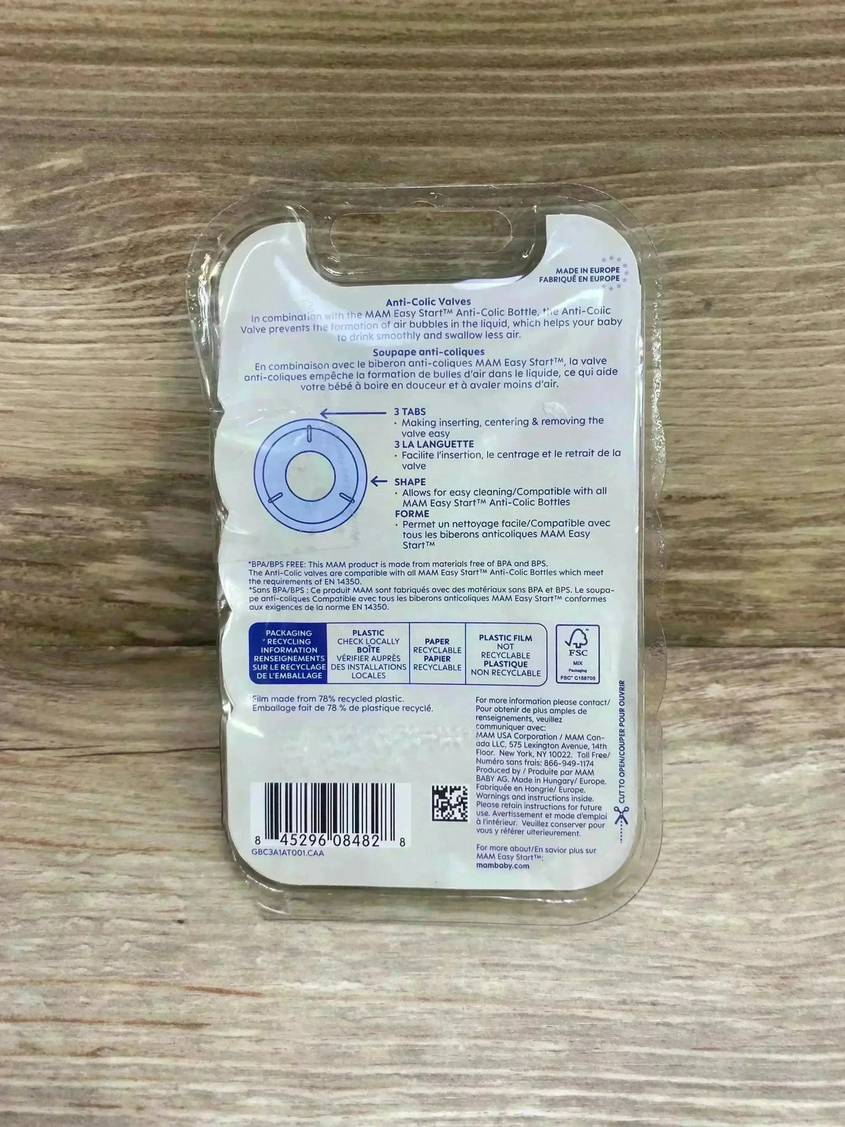 Back view of NEW MAM Easy Start anti-colic valve replacement pack showing packaging text Anti-Colic Valves, valve diagram and barcode on wood background