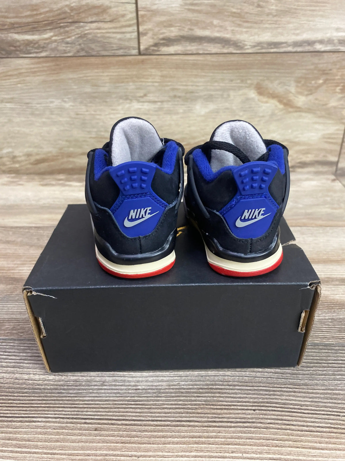 Rear view of new Air Jordan 4 Retro TD Rare Air sneakers in size 3C showing black and blue uppers with red and cream soles