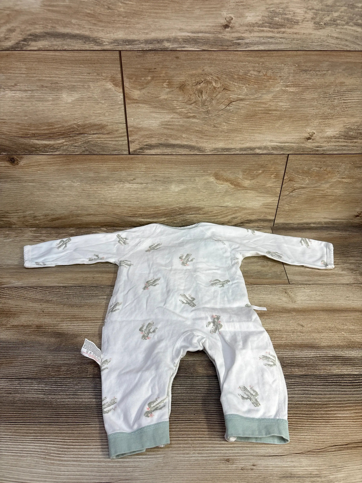 Front view of Cherie Kids white cactus print footless kimono sleeper showcasing long sleeves and sage cuffs