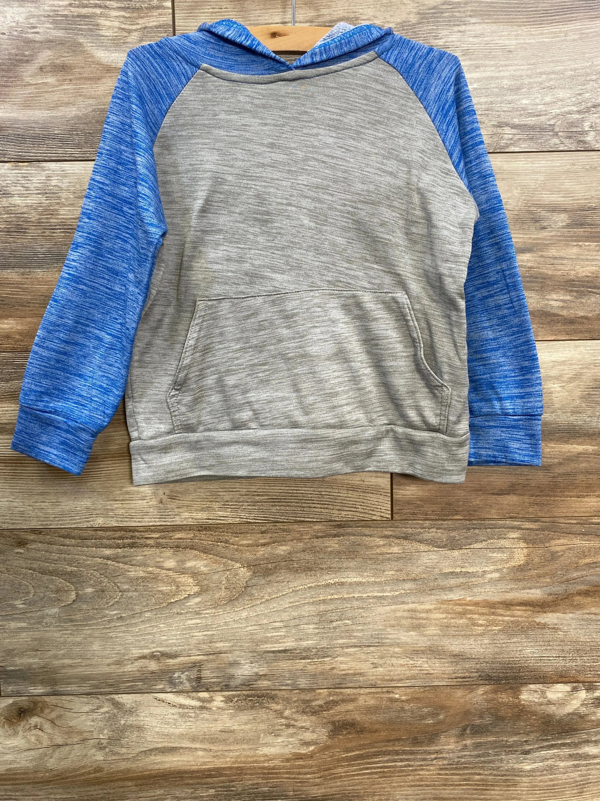 Gray and blue hooded long-sleeve sweatshirt with front pocket on wooden background