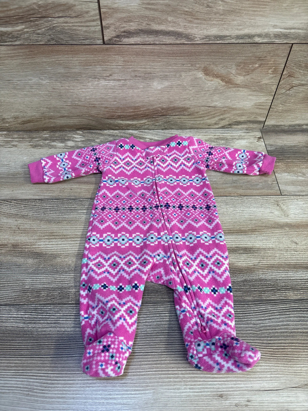 Pink Carter's newborn blanket sleeper with a white and blue fair isle pattern