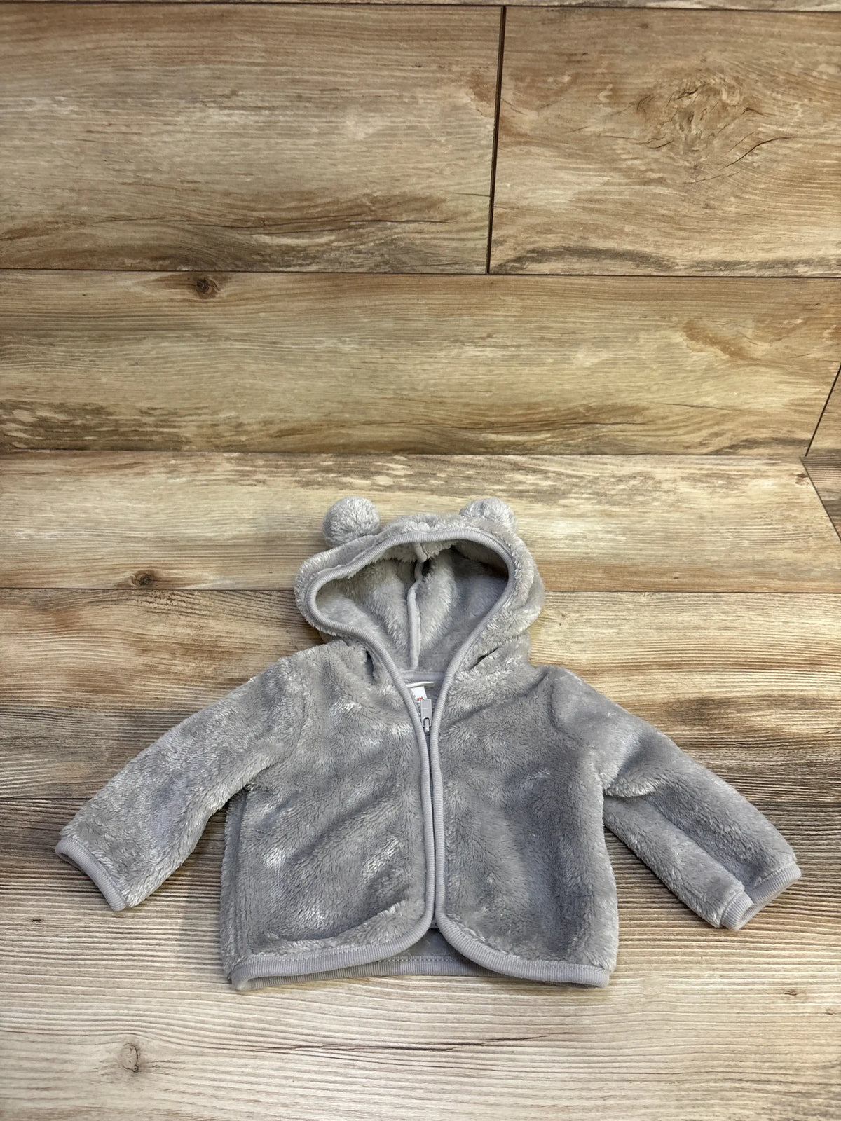 Grey Cat & Jack faux fur full-zip hooded jacket for newborns with animal ears on a wood background
