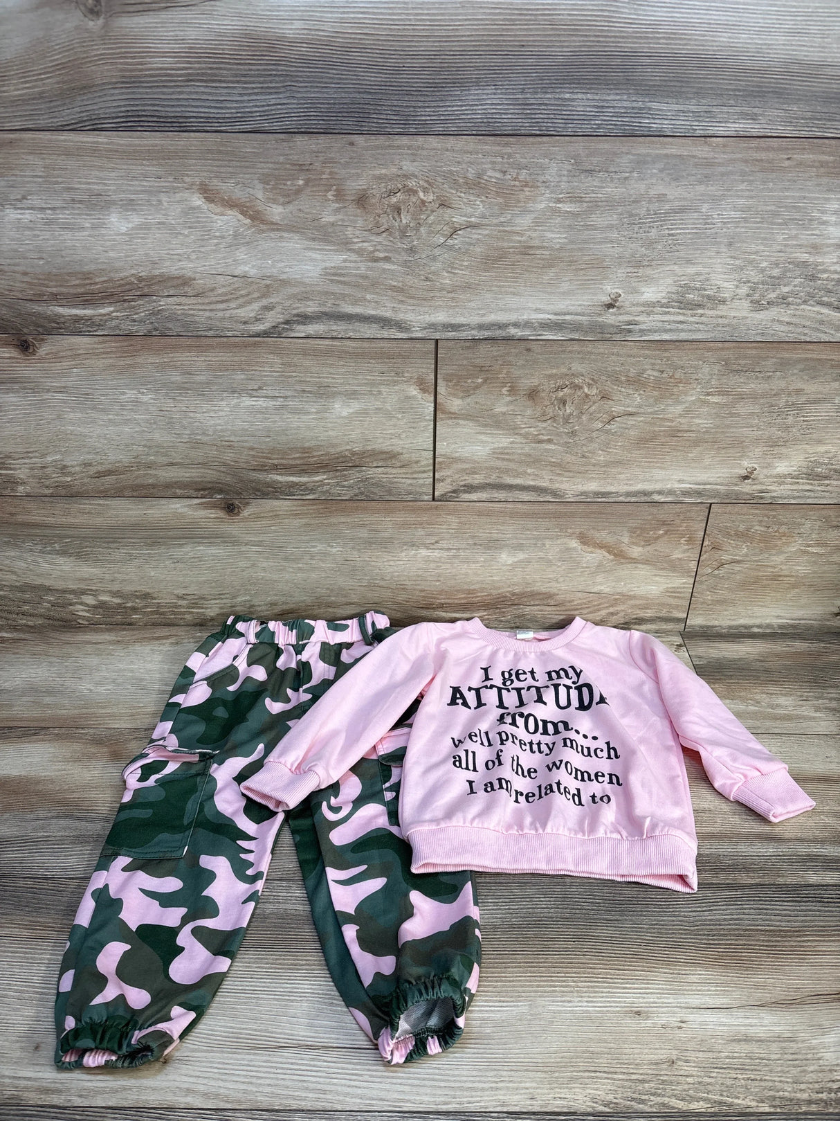 Pink graphic sweatshirt with 'I get my ATTITUDE' text and pink-green camo pants, kids clothing set
