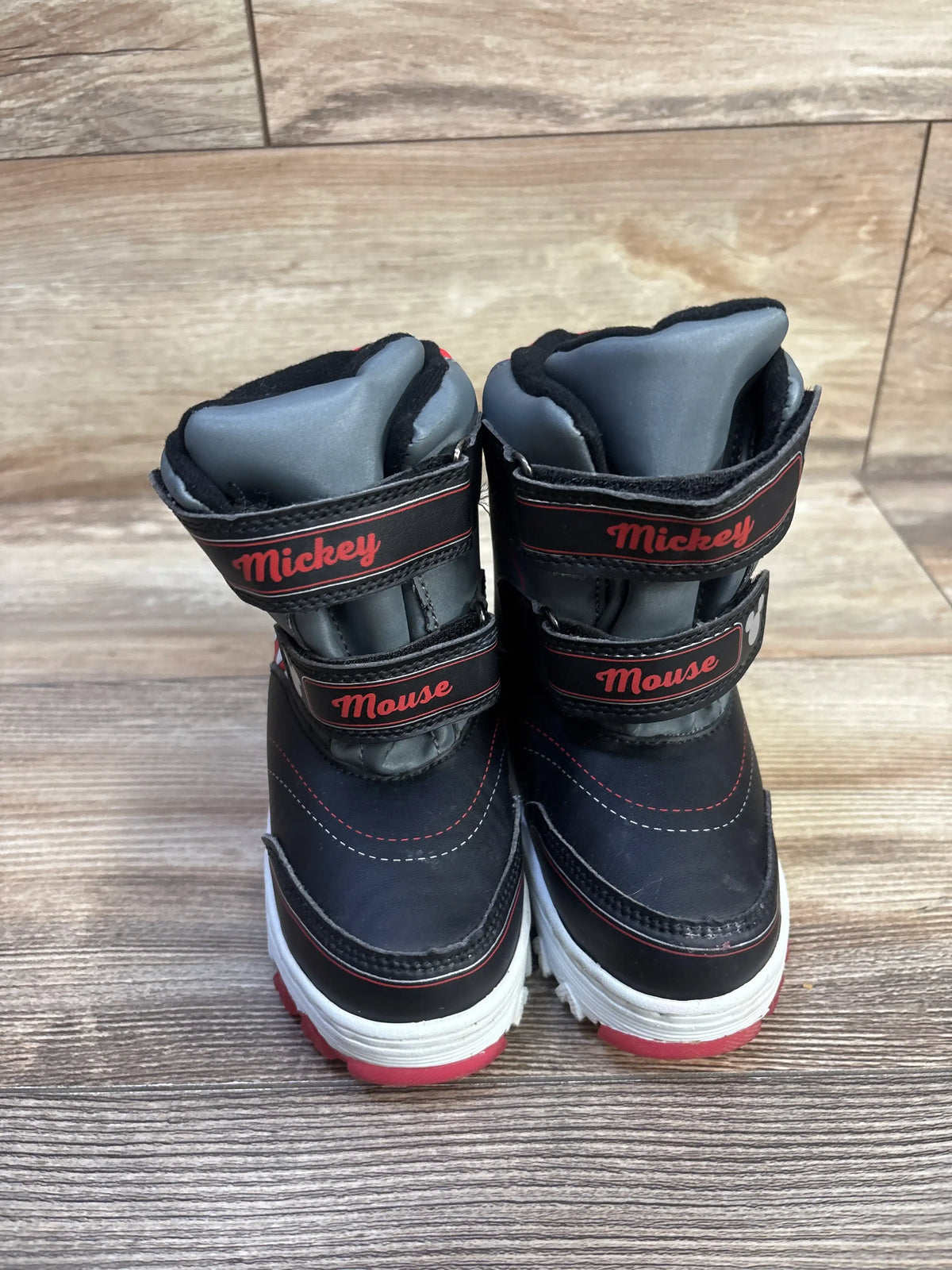 Front view of black Disney Junior Mickey Mouse snow boots with double hook and loop straps and white midsoles