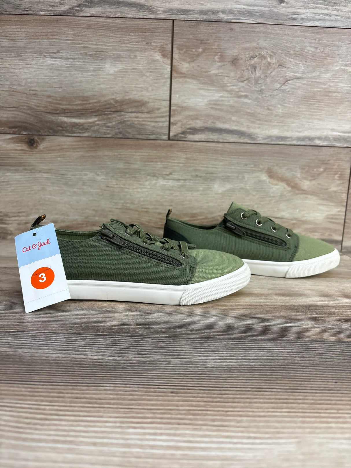 Pair of green Cat & Jack size 3 kids canvas sneakers with white rubber soles and side zippers