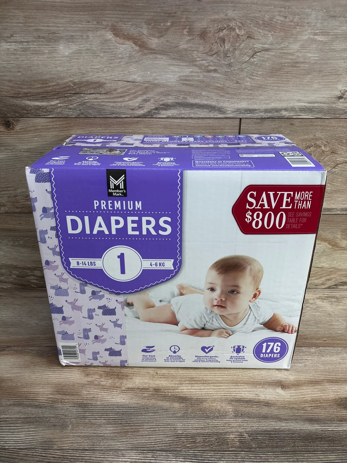 Box of Member's Mark premium size 1 diapers for babies, 176 count, on wood floor