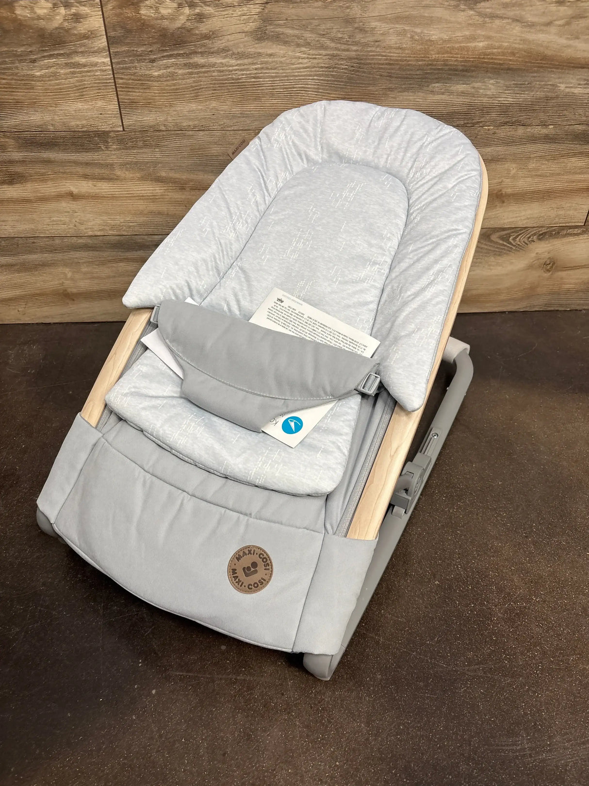 Angled top view of Maxi-Cosi Kori baby rocker in Classic Slate with padded grey seat and wood-look accents