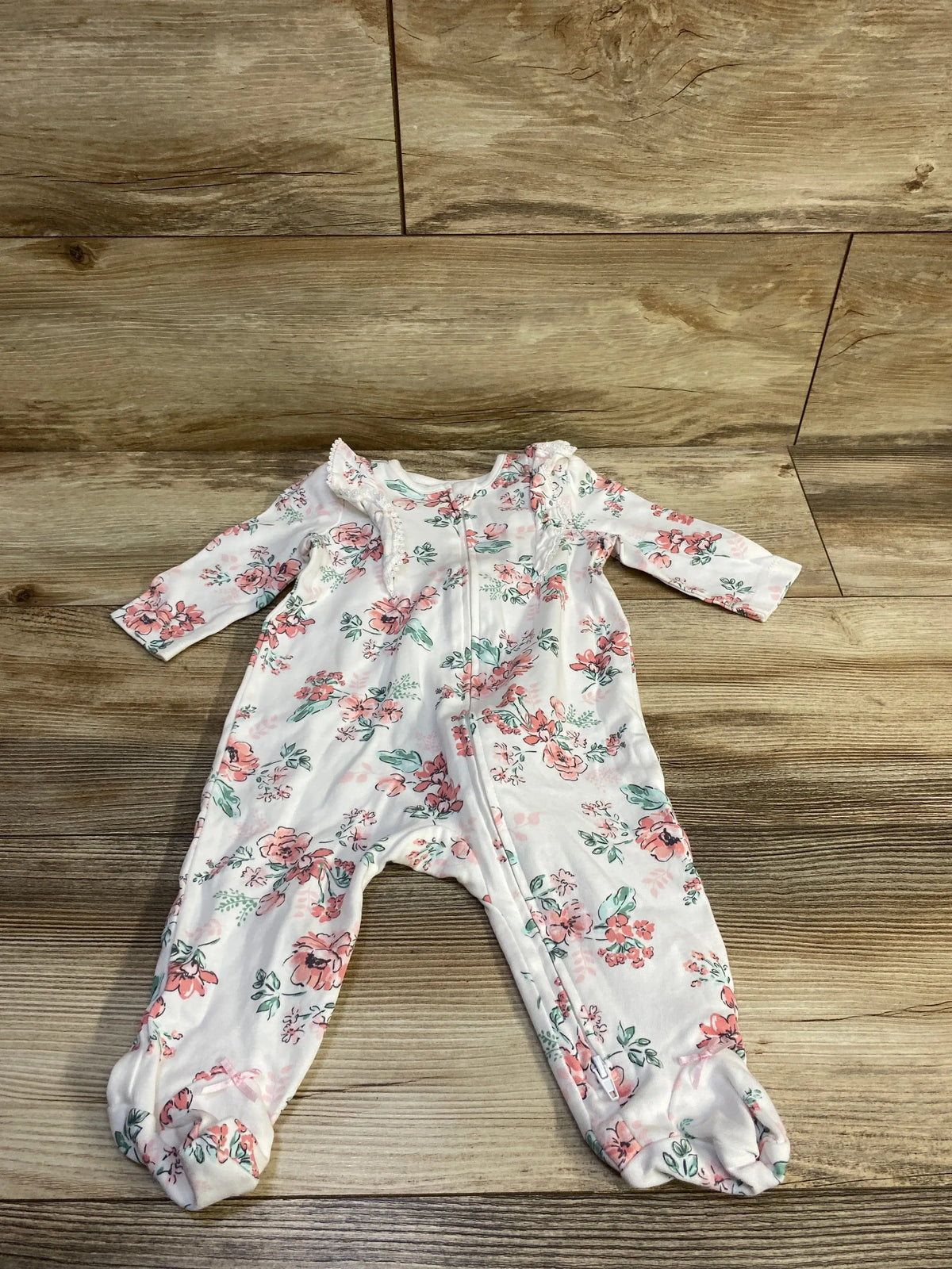 White Little Me floral sleeper for baby size 6m with pink flower print on wood background