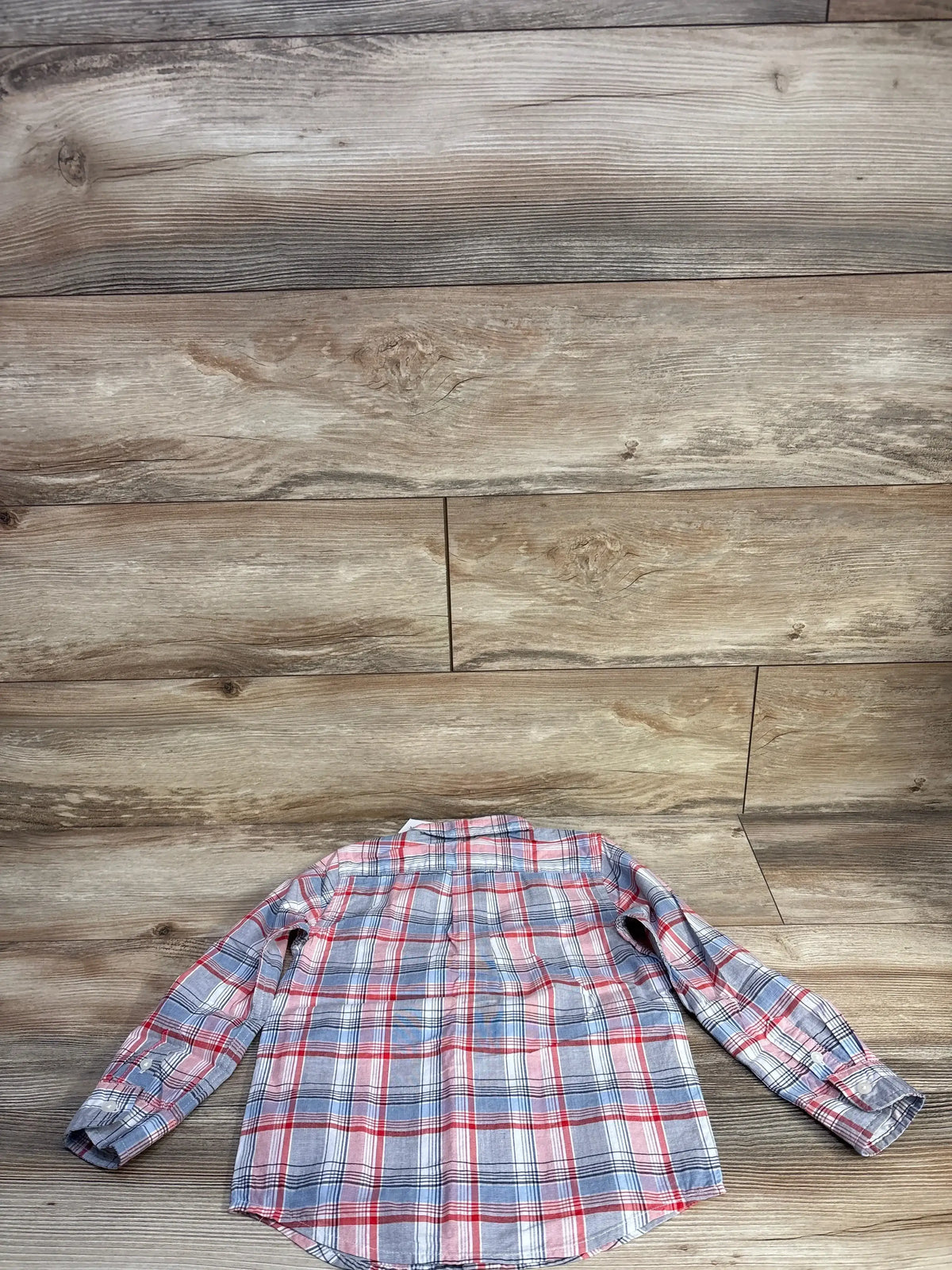 Back view of Janie and Jack red, white and blue plaid button-down shirt on wood floor