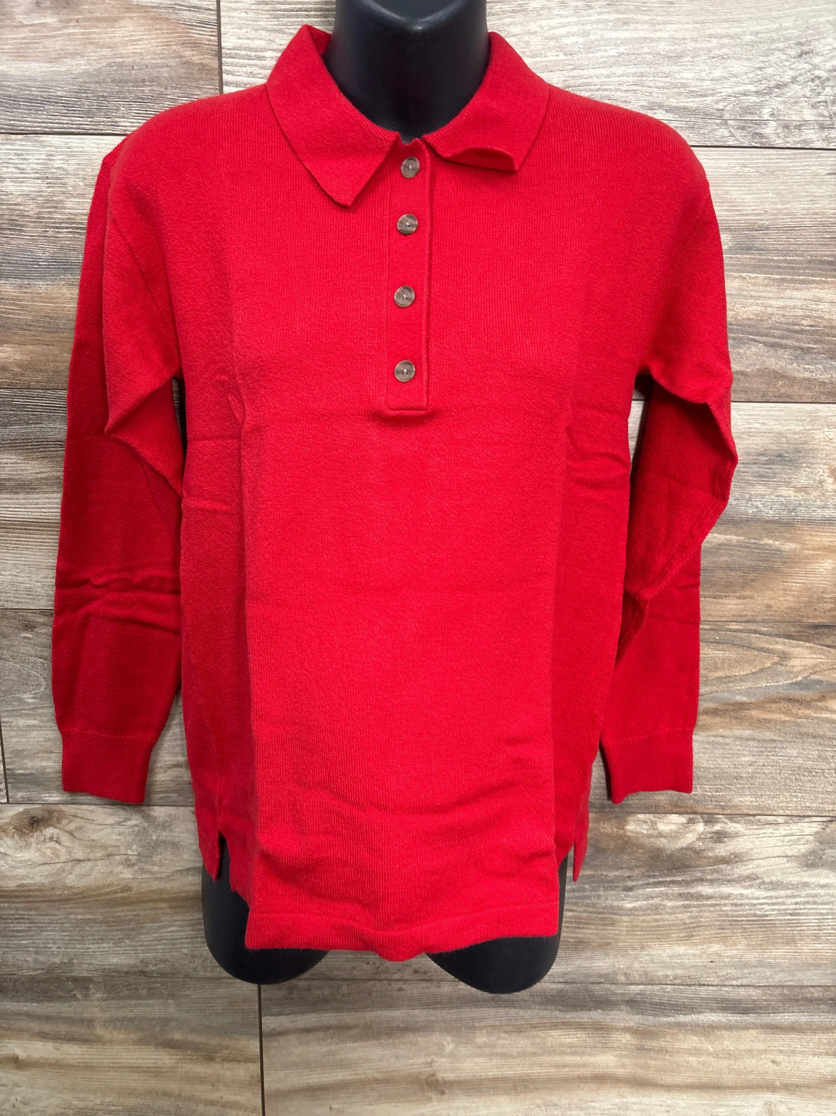 Red long sleeve knit collared shirt with buttons, kids clothing on wood background