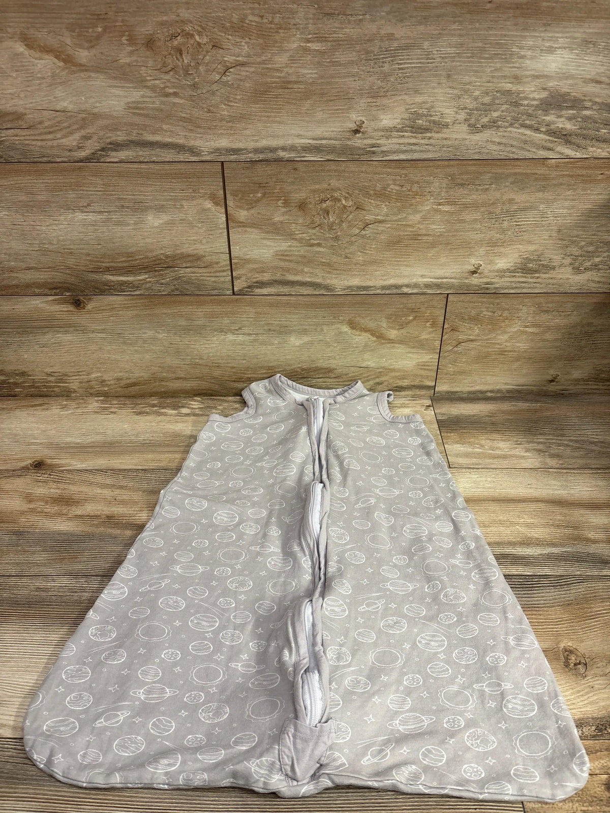 Grey Bublo baby sleep sack with white planet print, size 6-12m, laid flat on wood background