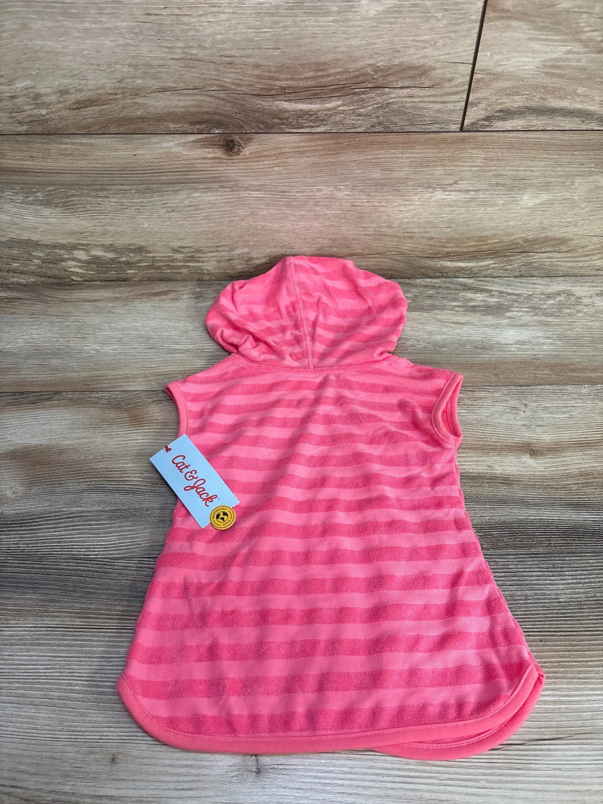 Back flat lay of Cat and Jack hooded baby swim cover-up, pink stripes, sleeveless on wood background