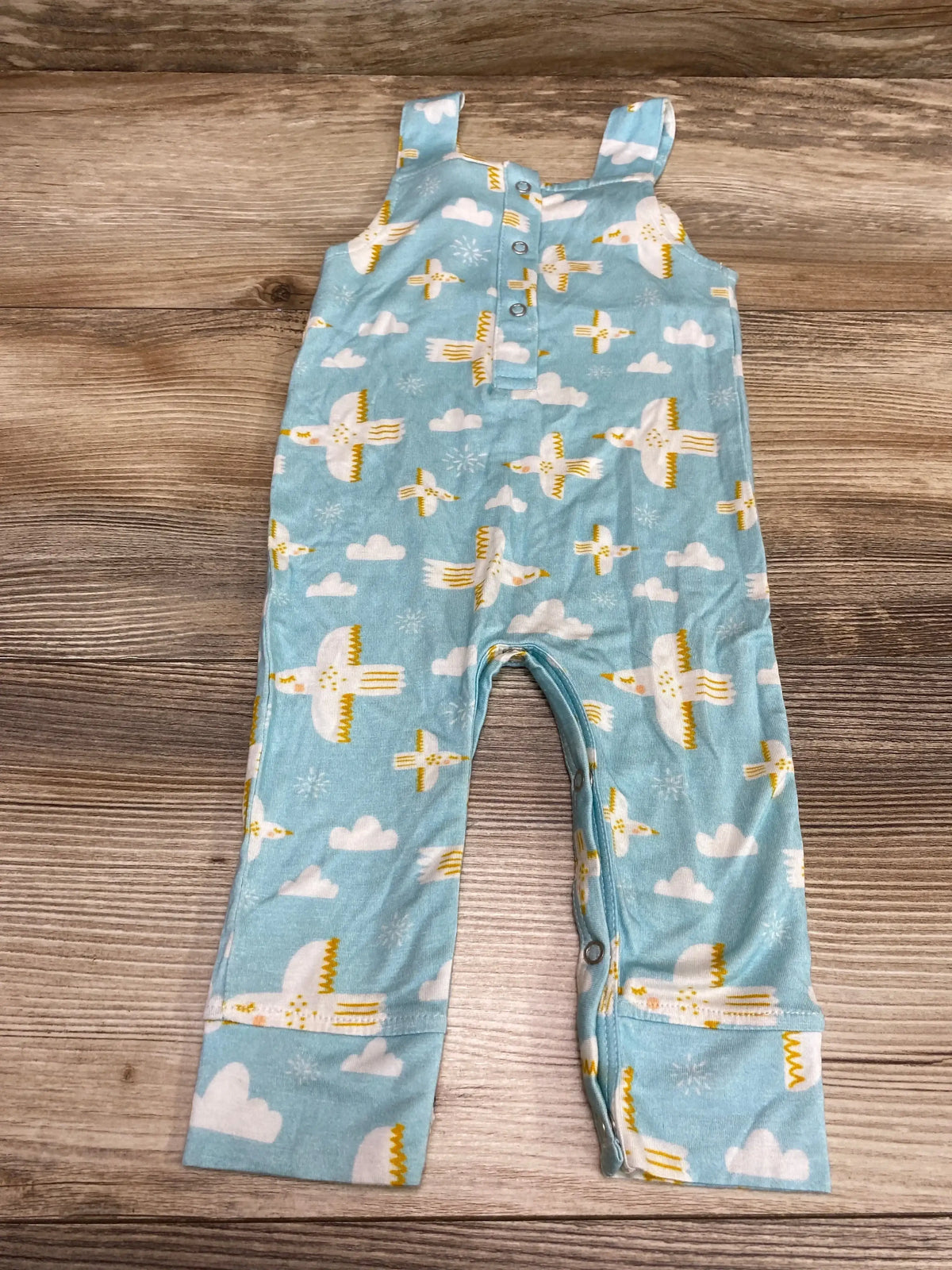 Front flat-lay of Larkspur bird-print baby overalls (3–6 months) showcasing shoulder straps, front snap placket and snap crotch