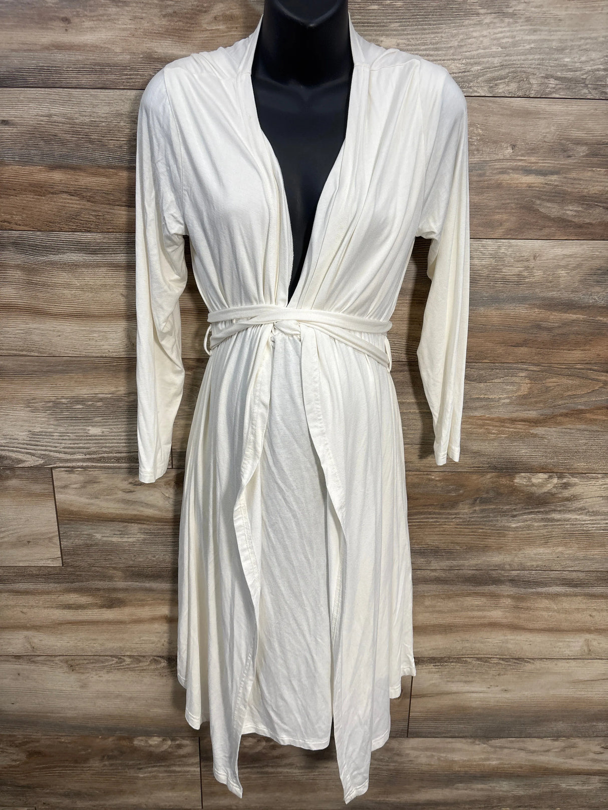 White maternity robe with tie belt and long sleeves on mannequin, wooden background