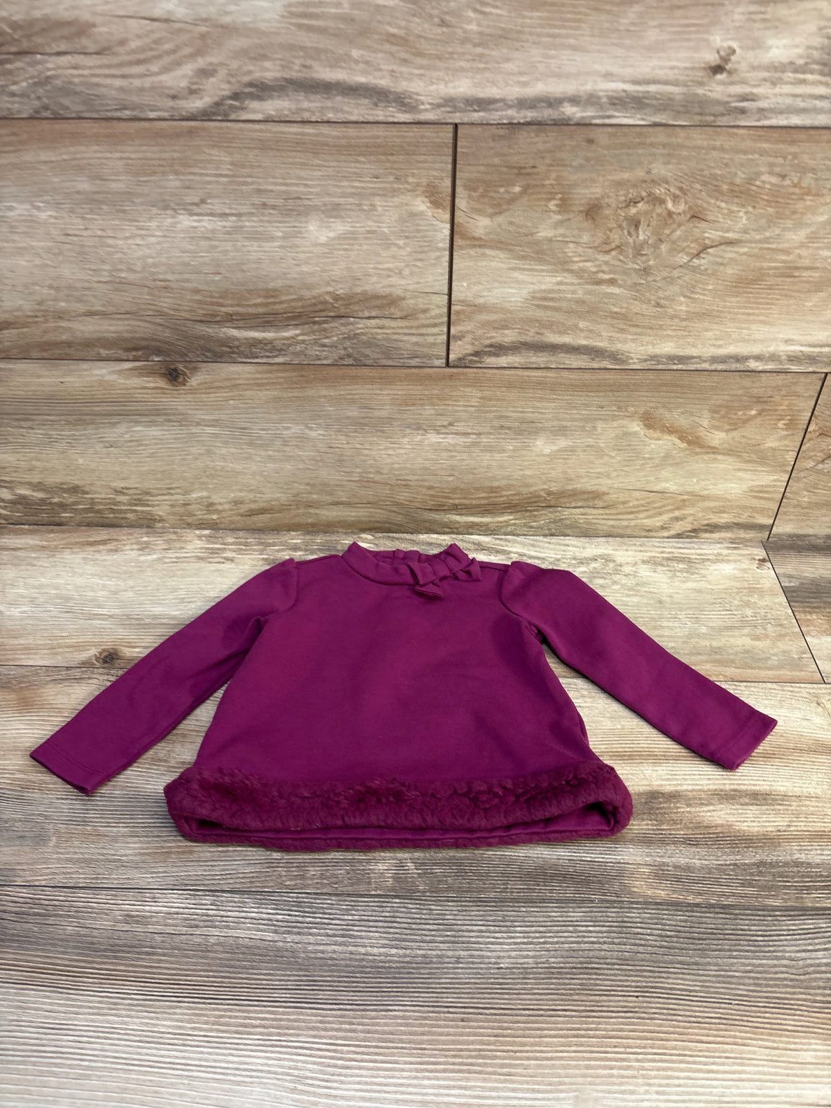 Purple Janie & Jack faux fur trim ponte top for baby size 12-18m on a wood background