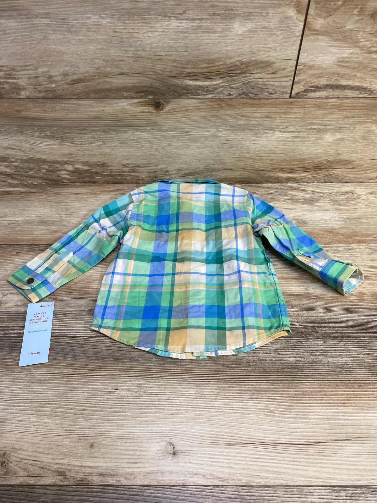 Back view of NEW Cat and Jack plaid button-up long sleeve shirt green and blue size 18m with hangtag on wood plank floor