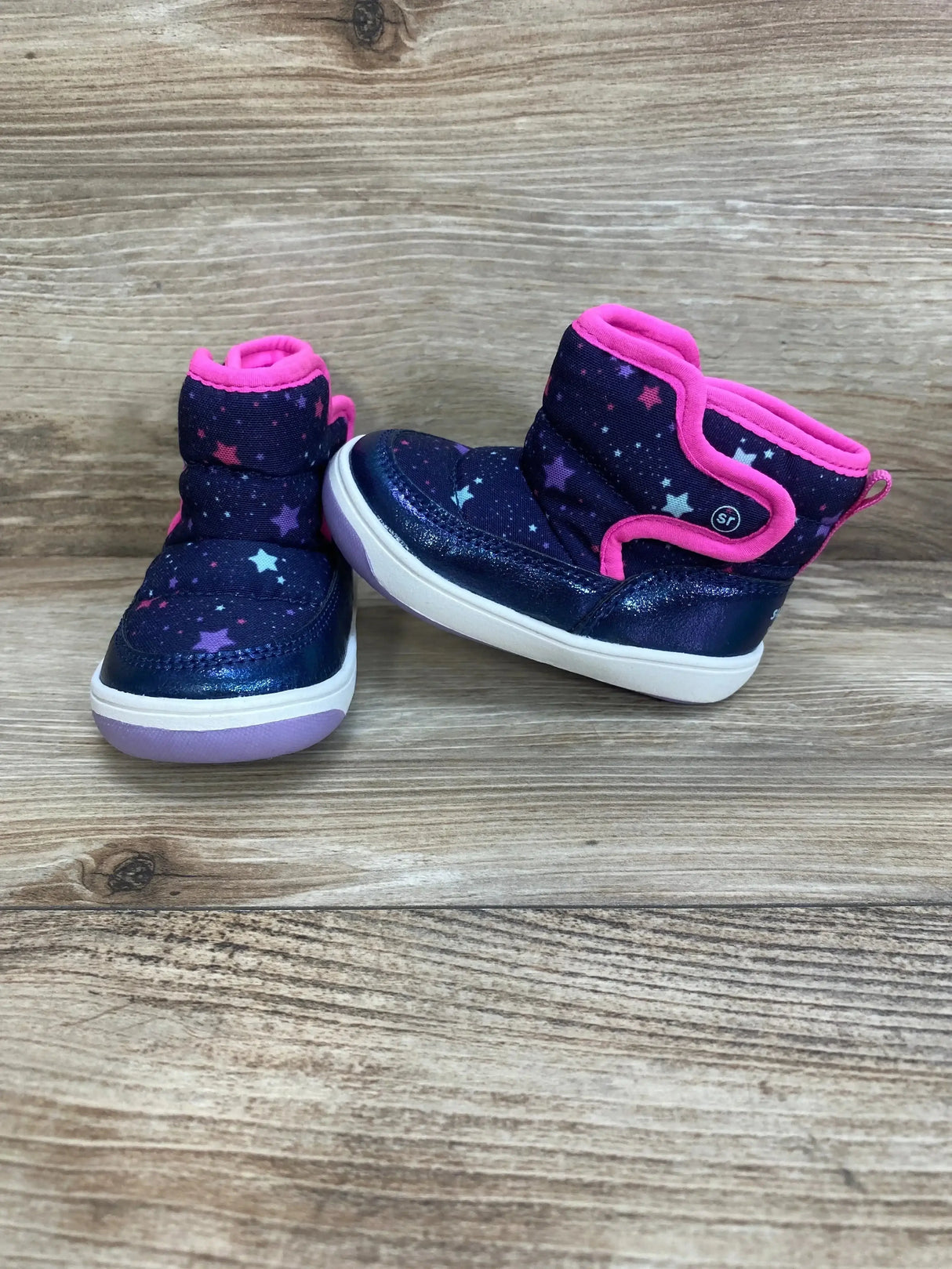 Front and side view of Surprize By Stride Rite Aster winter boots size 4C with navy star print, pink trim, Velcro strap