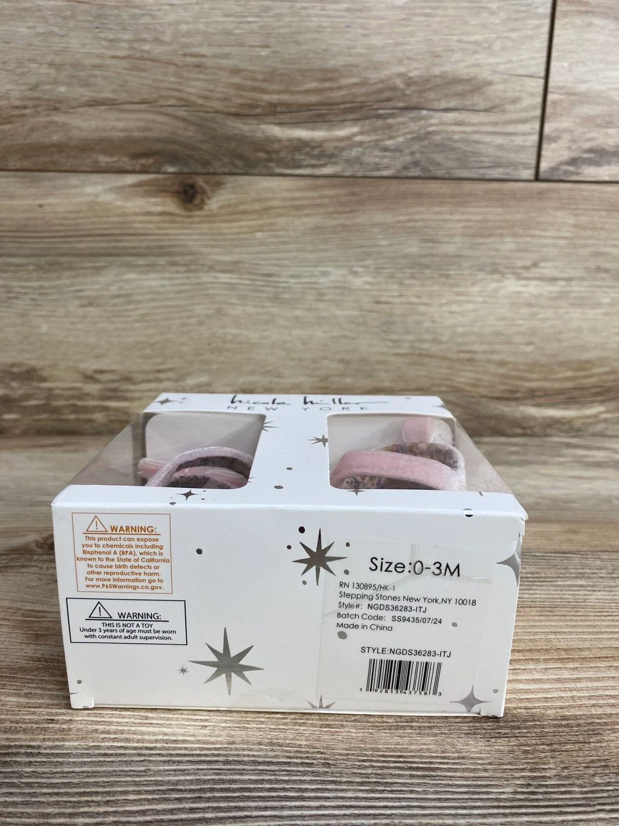 Box of pink baby booties size 0-3M with star pattern on white packaging, resale kidswear.