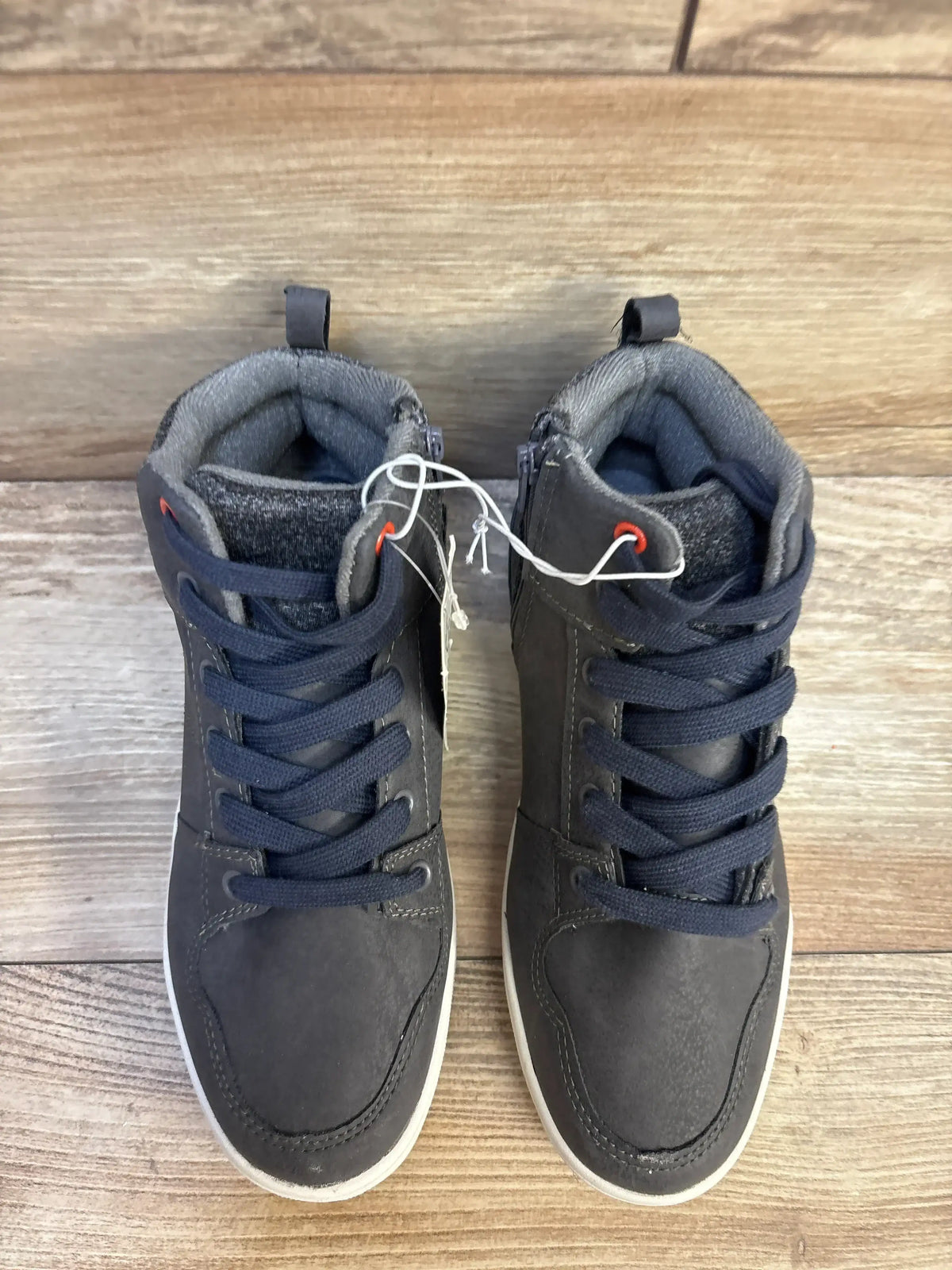 Top view of Art Class Geoff high-top kids sneakers grey 4Y with laces, side zippers, pull tabs and white soles on wood floor