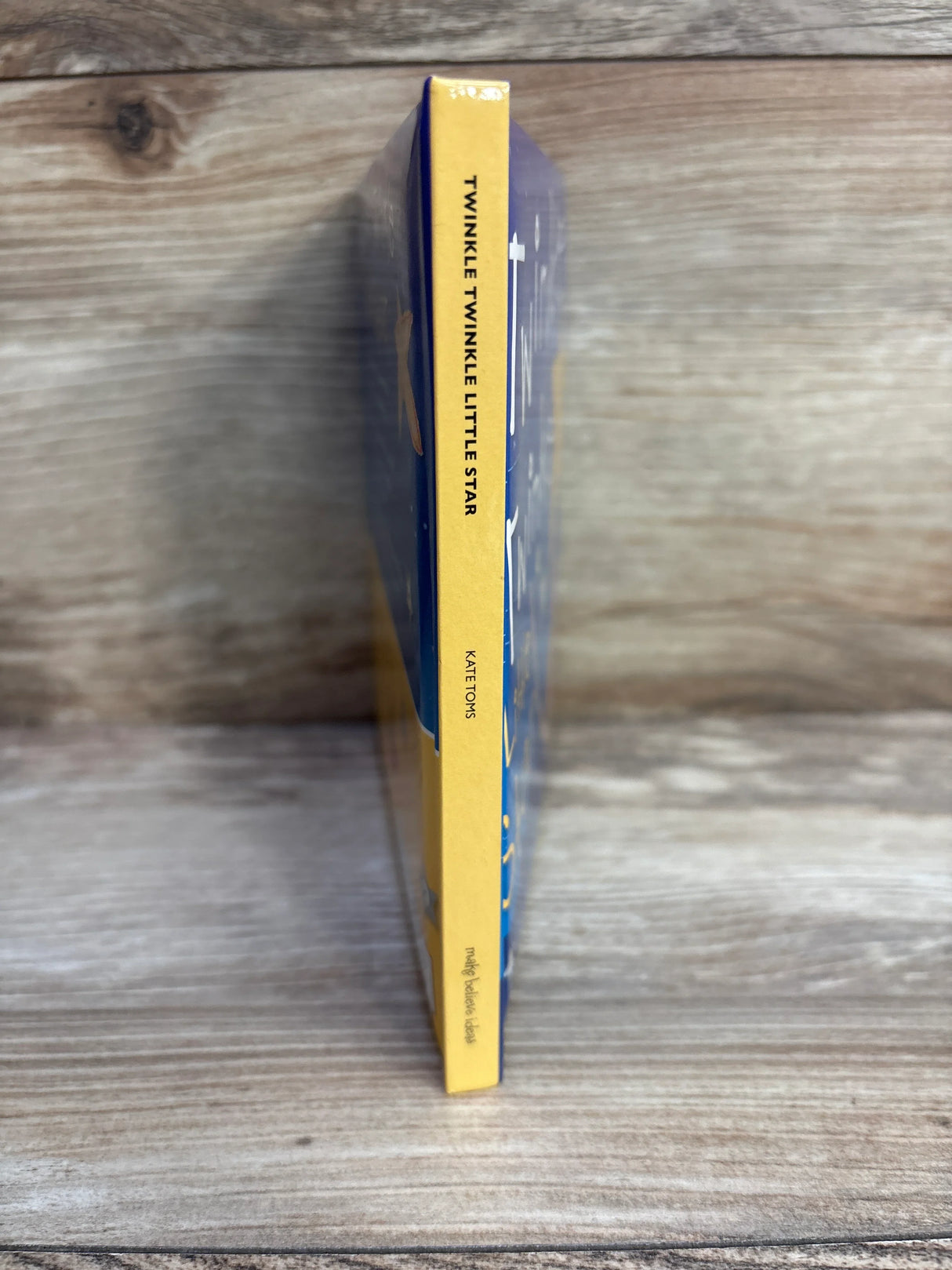 Twinkle Twinkle Little Star book spine by Kate Toms on wooden background