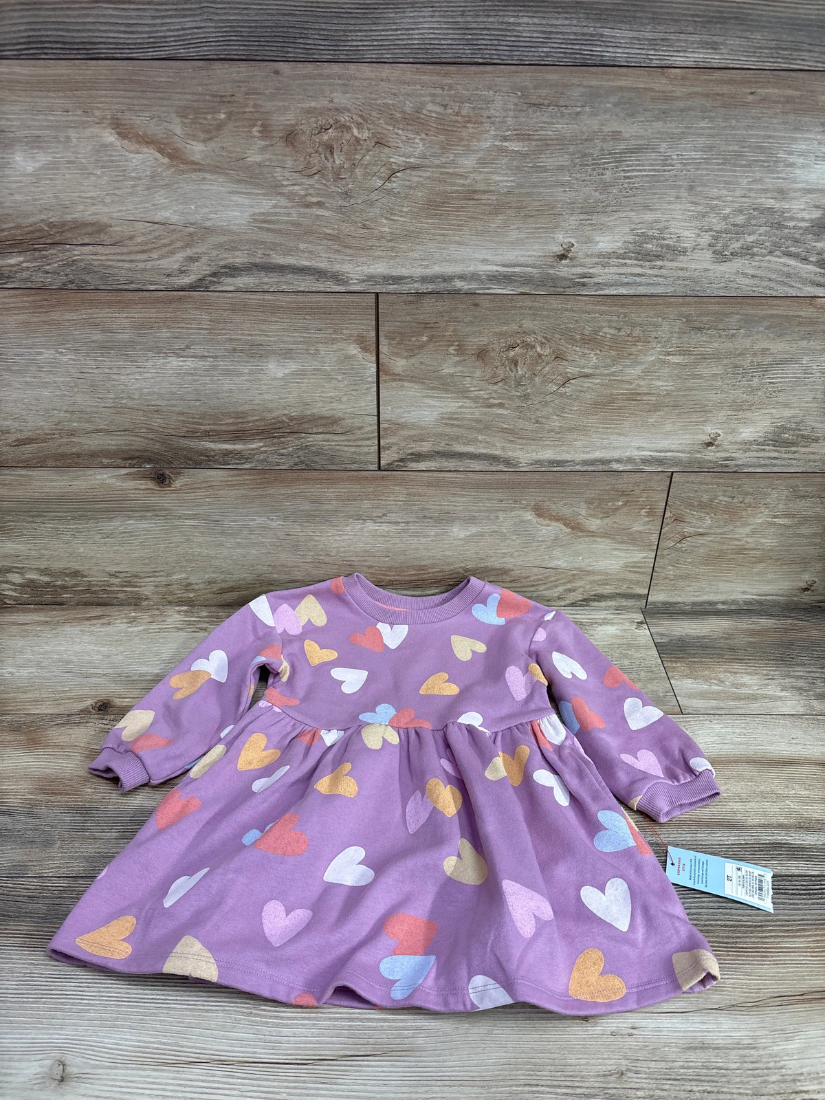 New purple Cat & Jack heart print sweatshirt dress for toddlers size 2T on wood background