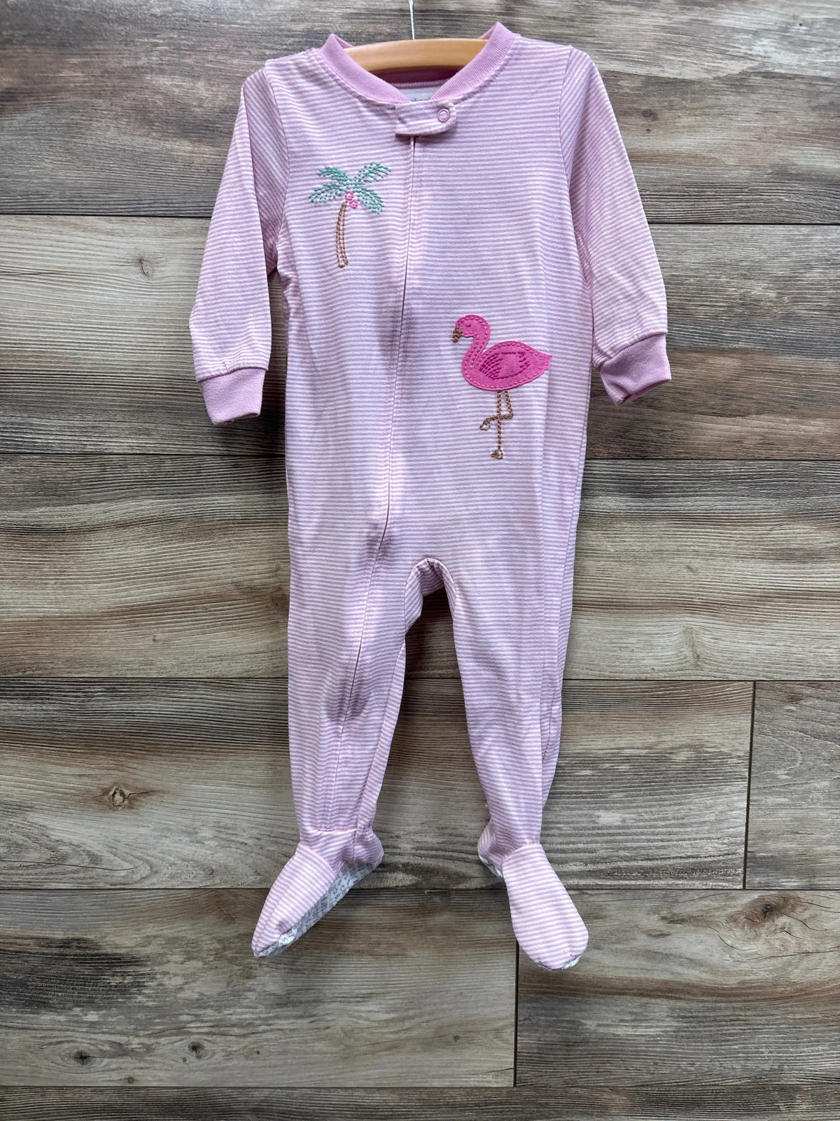 Front view of Just One You pink striped flamingo sleeper, size 18 months, showcasing footed legs on a wood background