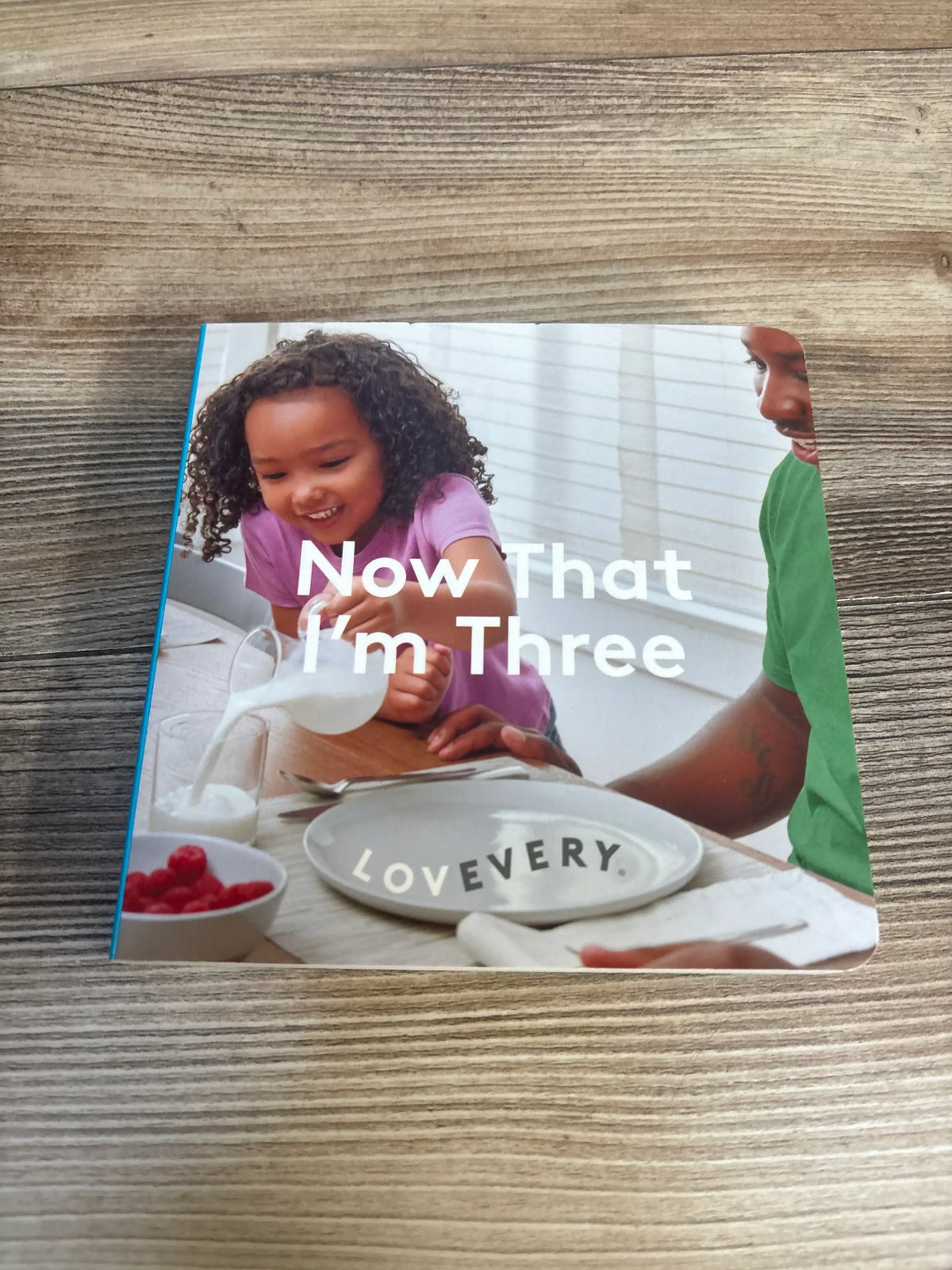 Now That I’m Three children’s book with a smiling child and parent at breakfast table
