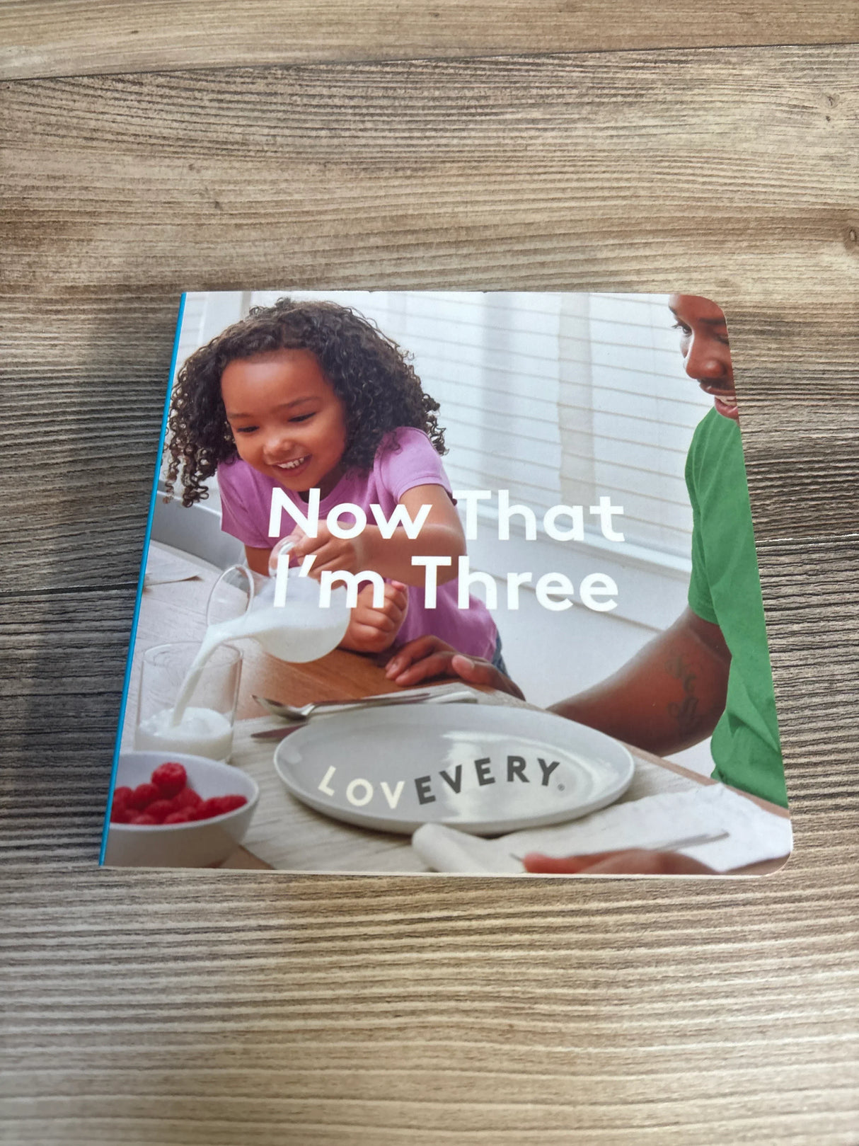 Now That I’m Three children’s book with a smiling child and parent at breakfast table