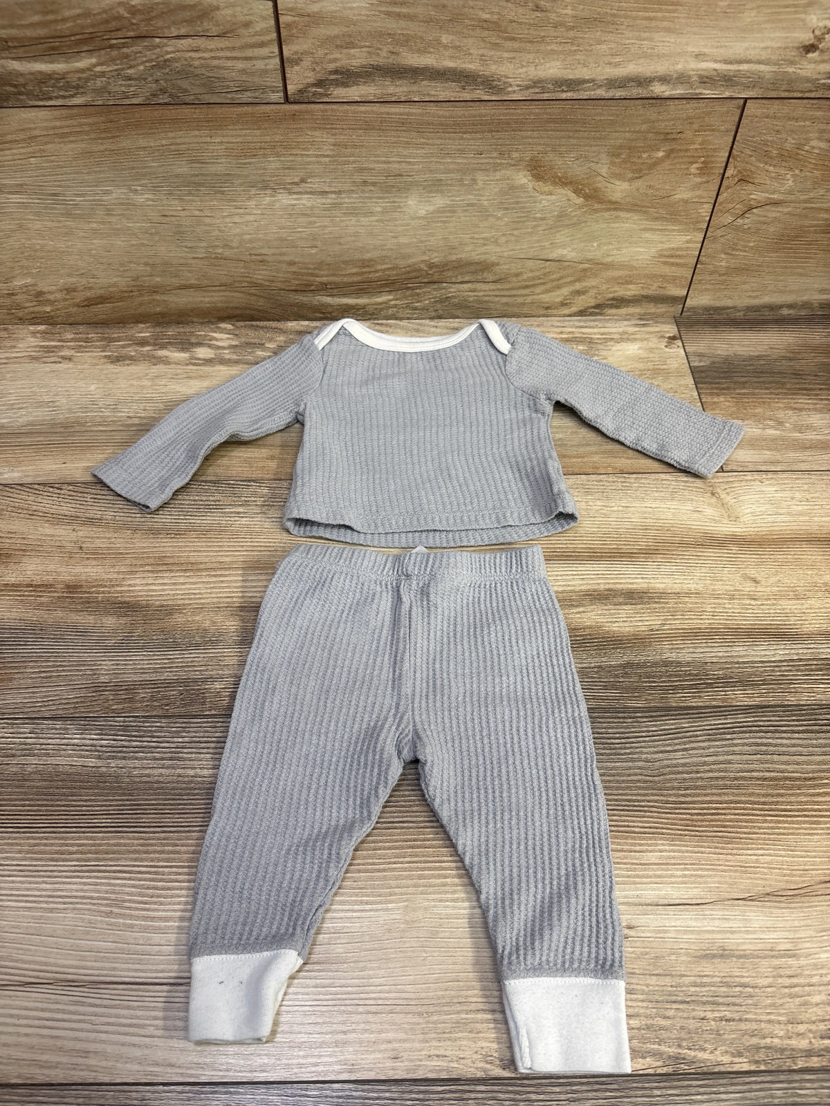 Flat lay of Cloud Island 2pc gray textured shirt and pants set with white trim on a wood background