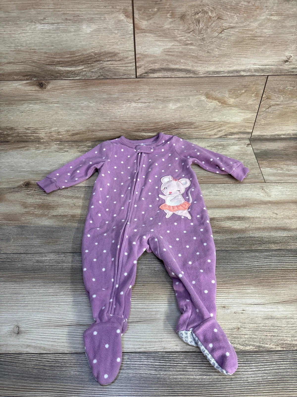 Front view of Carter’s purple blanket sleeper showcasing white polka dots, footed legs, and mouse applique on wood-look flooring