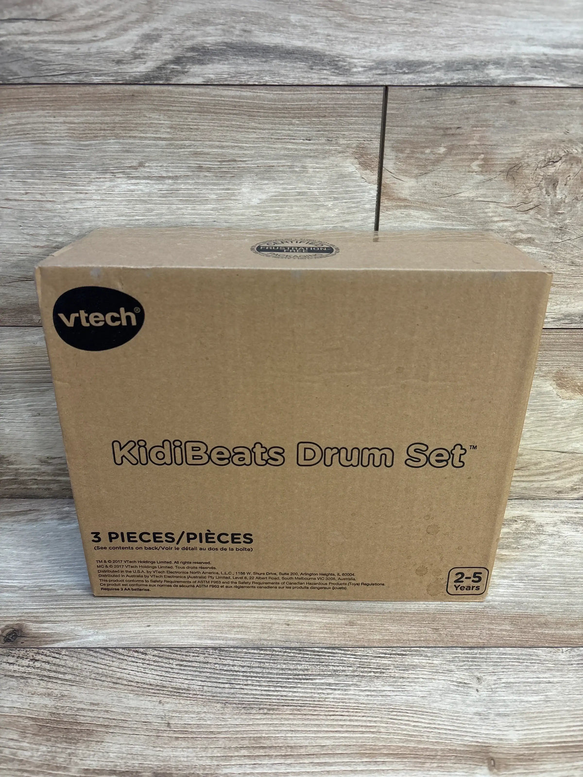 VTech KidiBeats Drum Set box for ages 2-5, unopened, on wood background