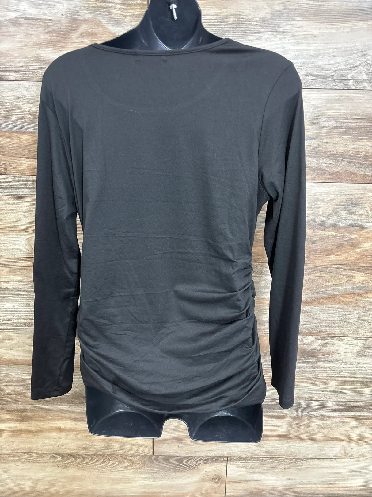 Black long sleeve maternity top with side ruching displayed on mannequin