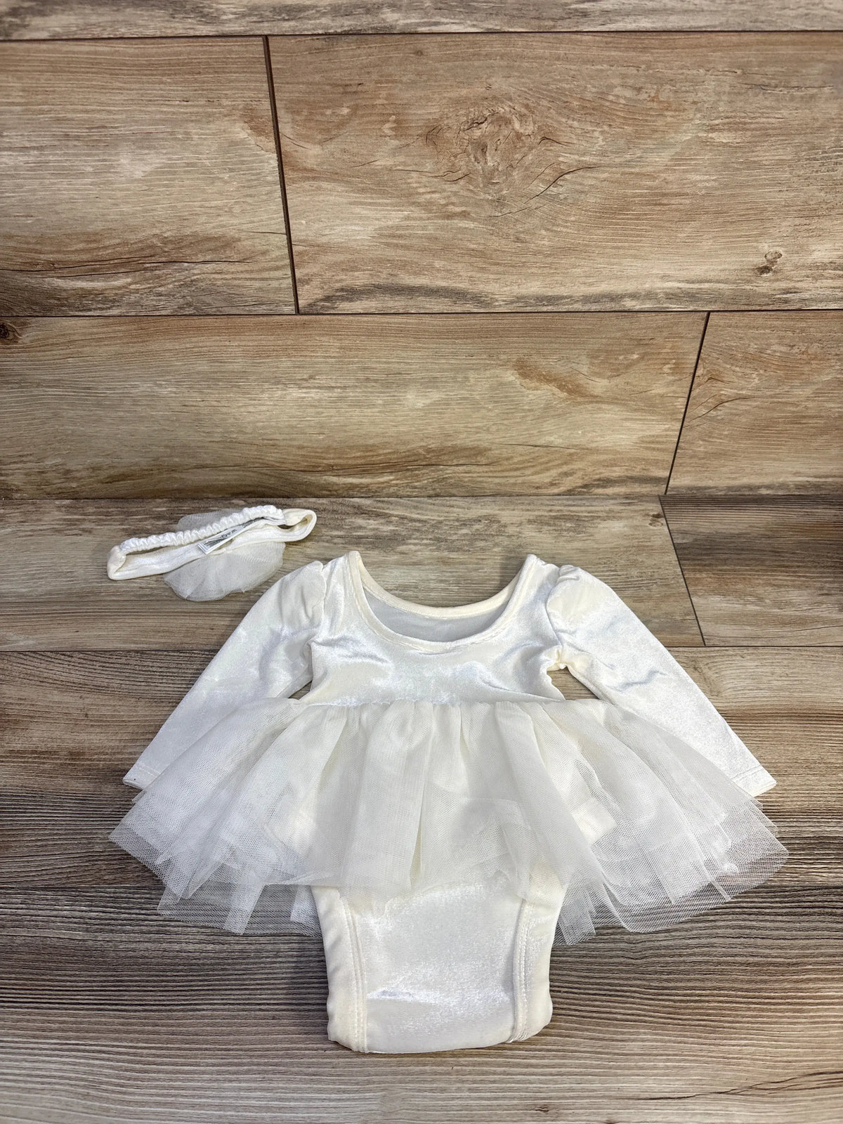 Front view of Baby Gap ivory velvet bodysuit dress set with flower headband, puff sleeves, and layered tulle skirt