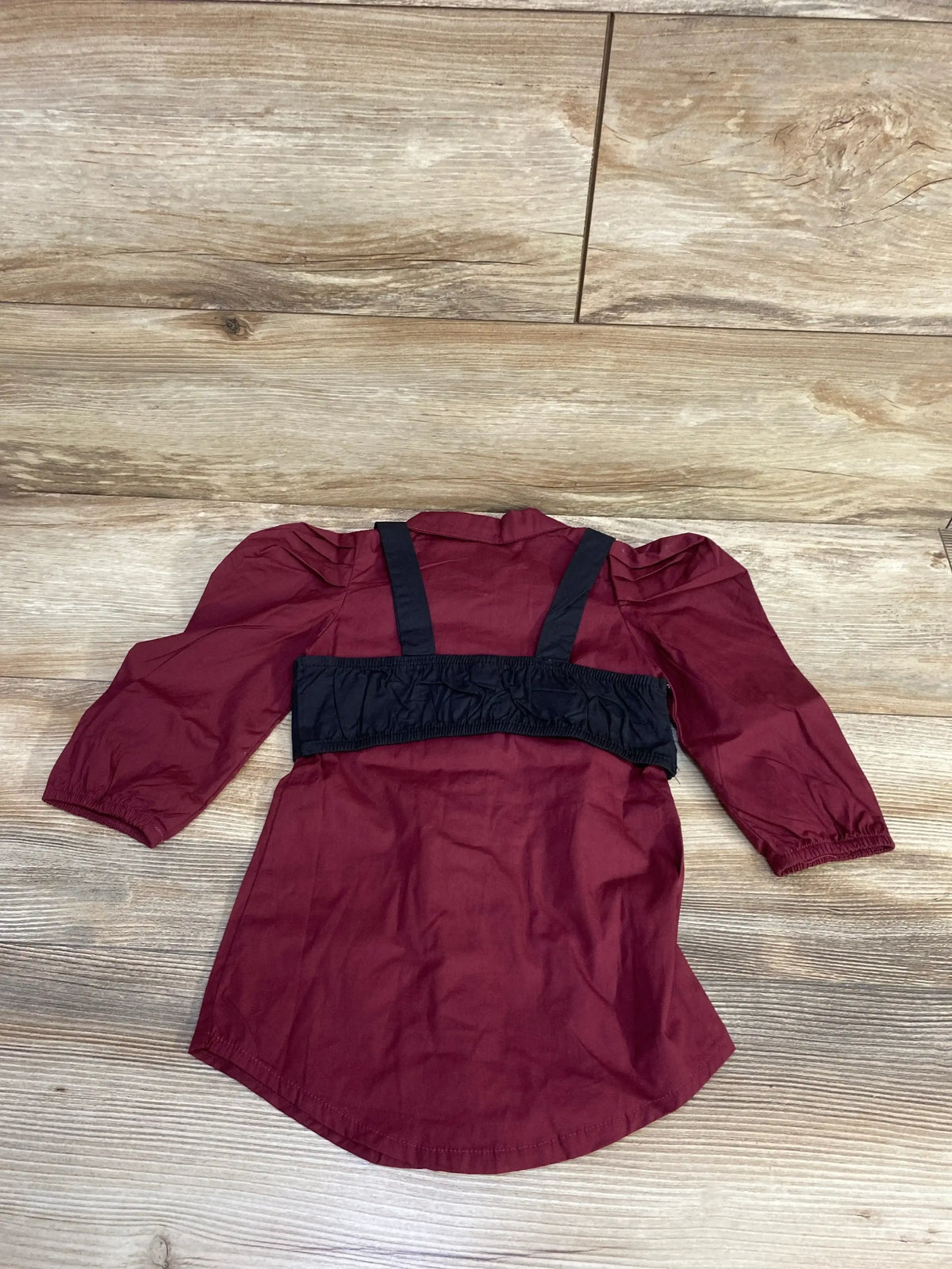 Back view of Shein 2pc Button Up Dress and Vest Set burgundy sz 12m showcasing puff sleeves and black vest on wood floor