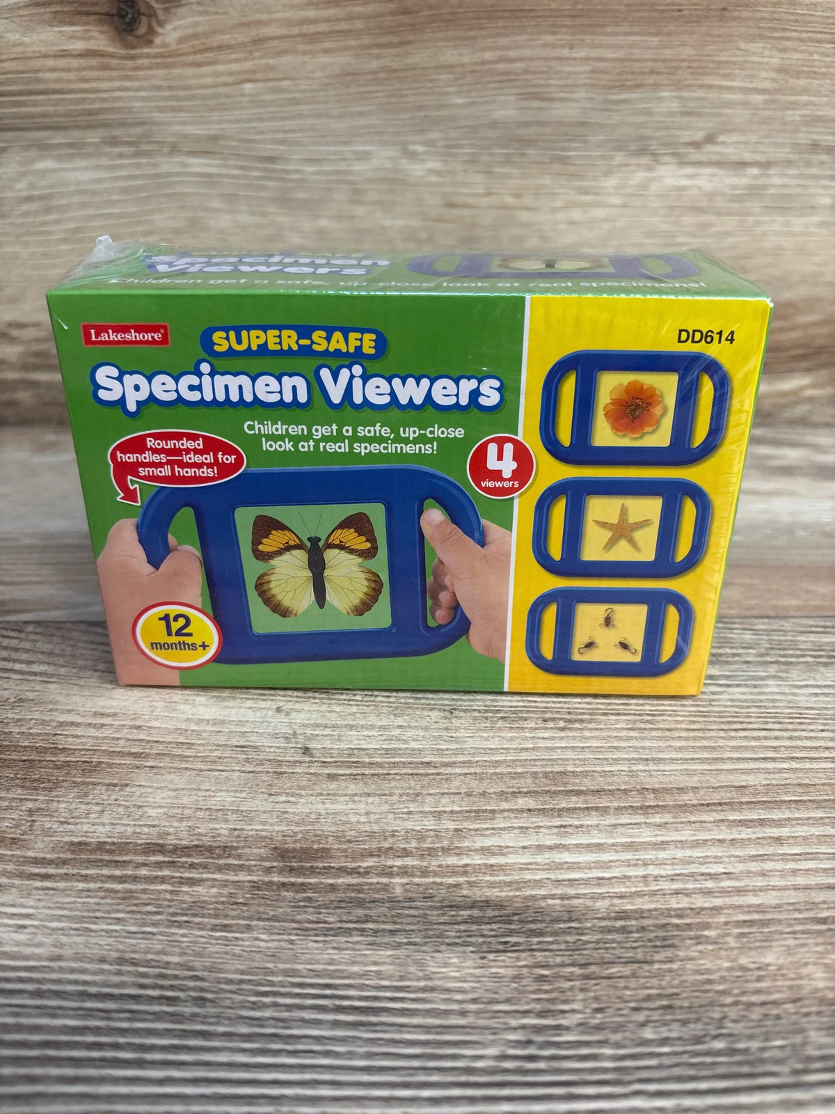 Front view of Lakeshore Super-Safe Specimen Viewers box showing blue viewer with rounded handles and butterfly image on wood surface