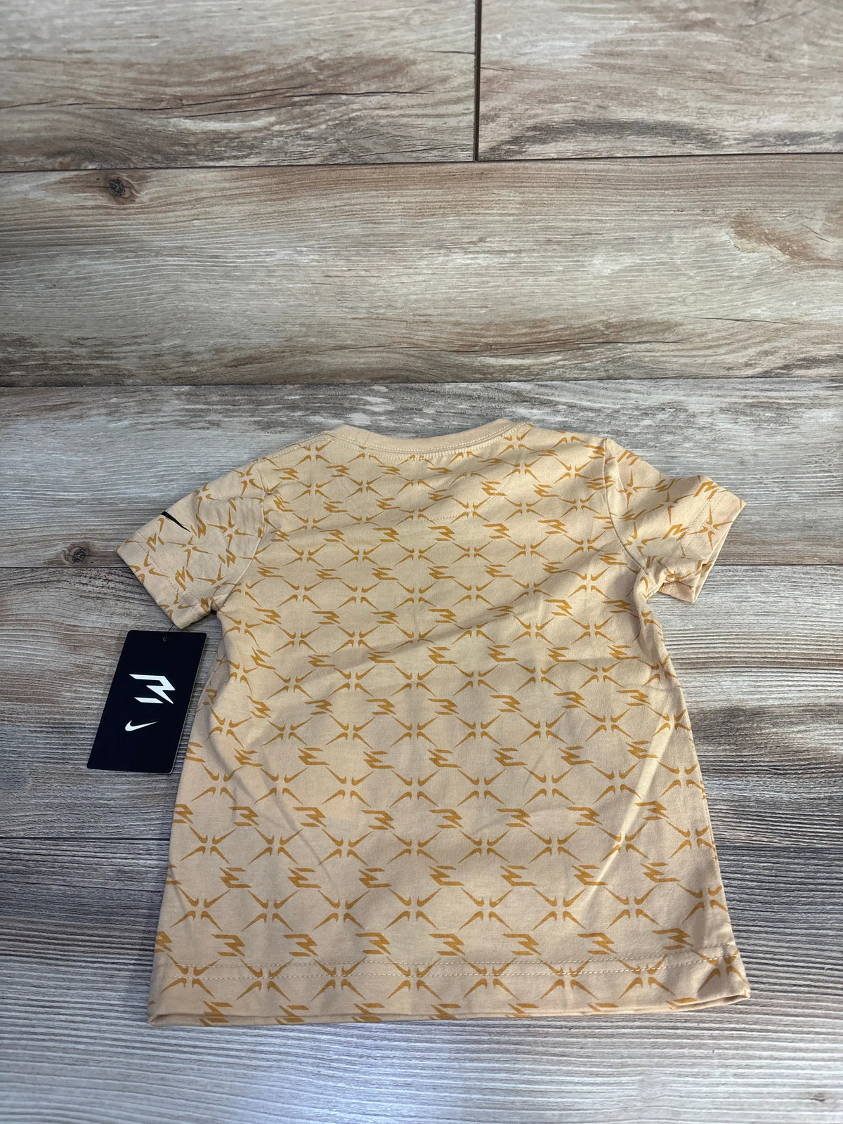 Front view of Nike x 3BRAND toddler shirt in sesame beige with gold pattern, short sleeves, crew neck, size 3T