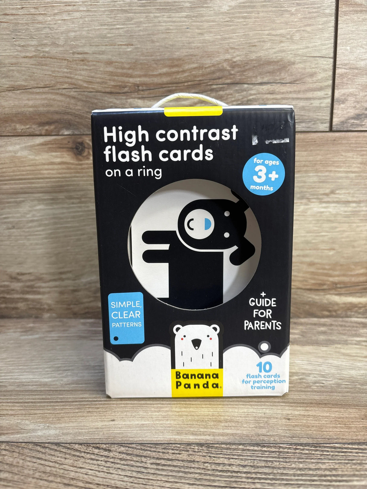High contrast flash cards for babies, ages 3 months+, in Banana Panda packaging on wood background.