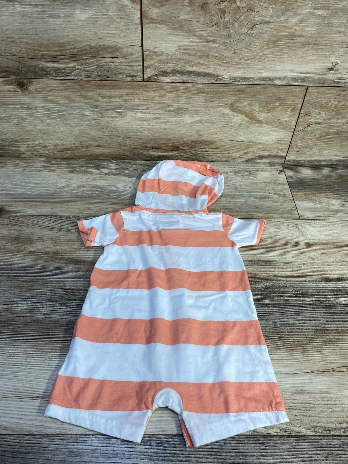 Back view of Carter's hooded shortie romper, white and coral stripes, hood and short sleeves, on wood floor, size 6-9m