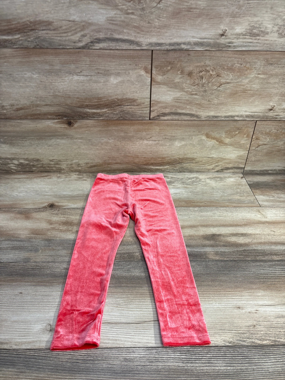 Flat lay of Okie Dokie crushed velvet toddler leggings in red, size 3T, on a wood floor