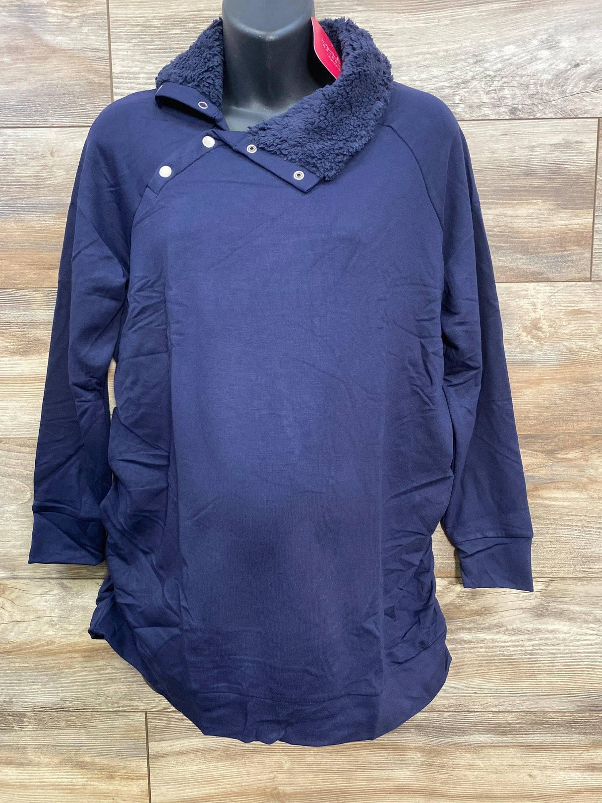 Navy blue long-sleeve sweater with a sherpa collar and snap buttons on a black mannequin