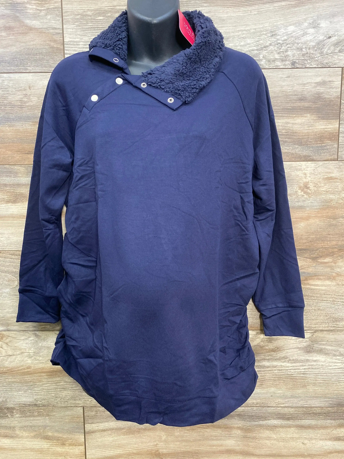 Navy blue long-sleeve sweater with a sherpa collar and snap buttons on a black mannequin