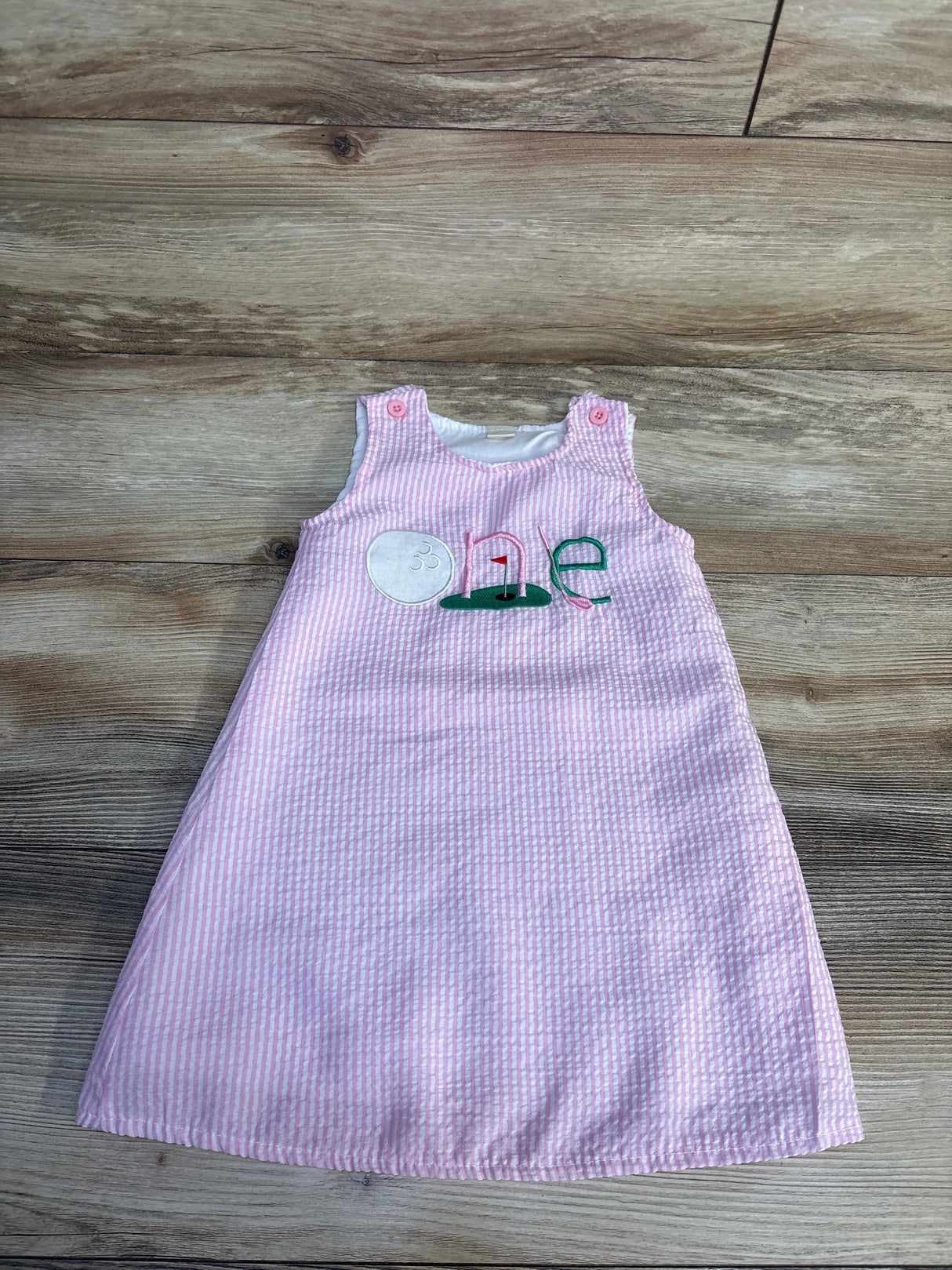 Pink and white striped baby dress with 'one' golf theme embroidery, perfect for first birthday outfits.